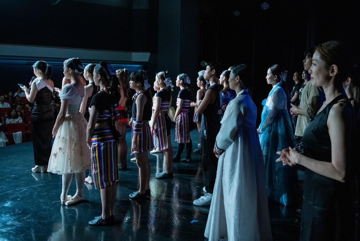 Woman smiling at orange smartphone.