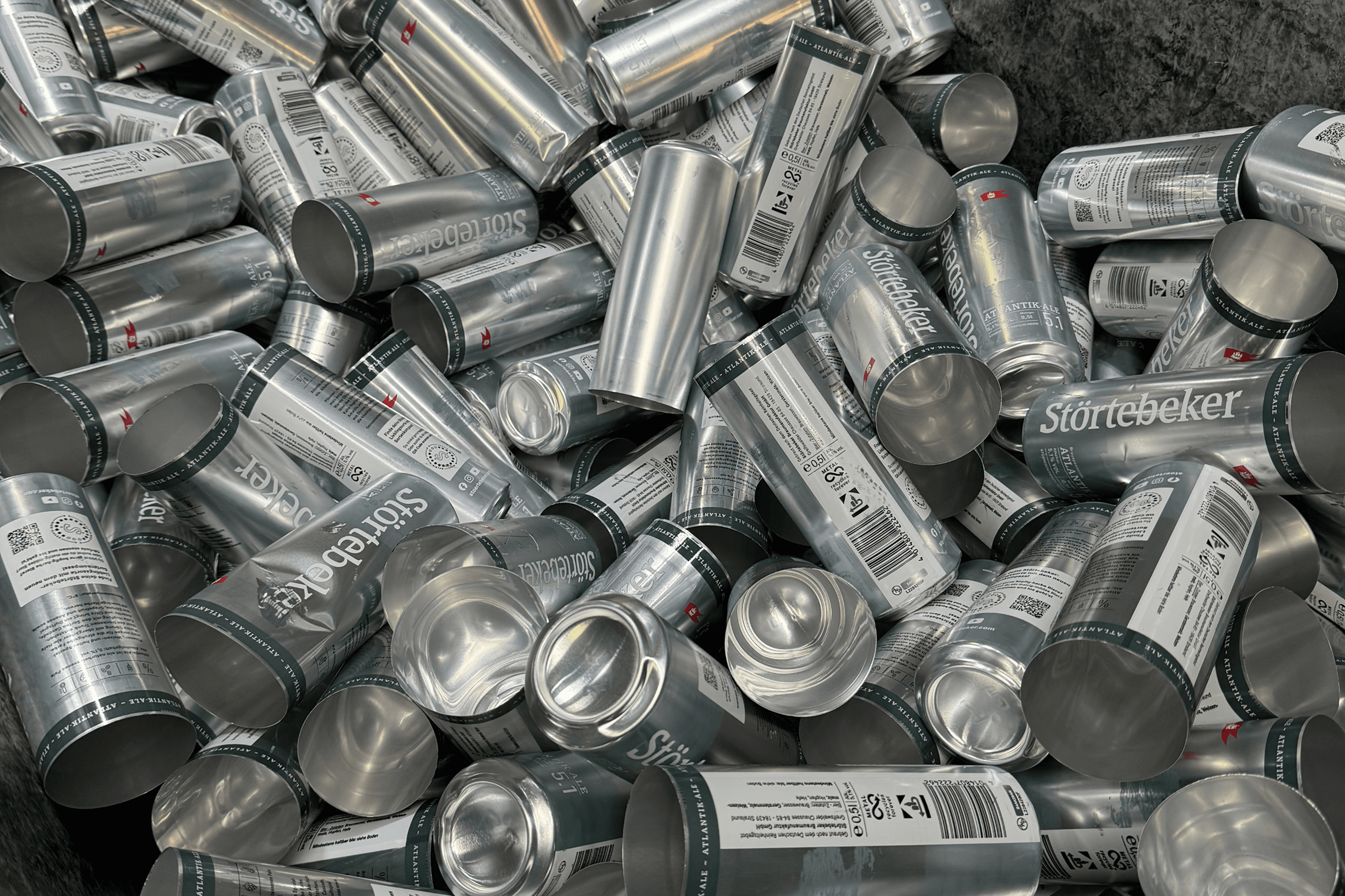 Pile of aluminum cans, many labeled "Störtebeker".