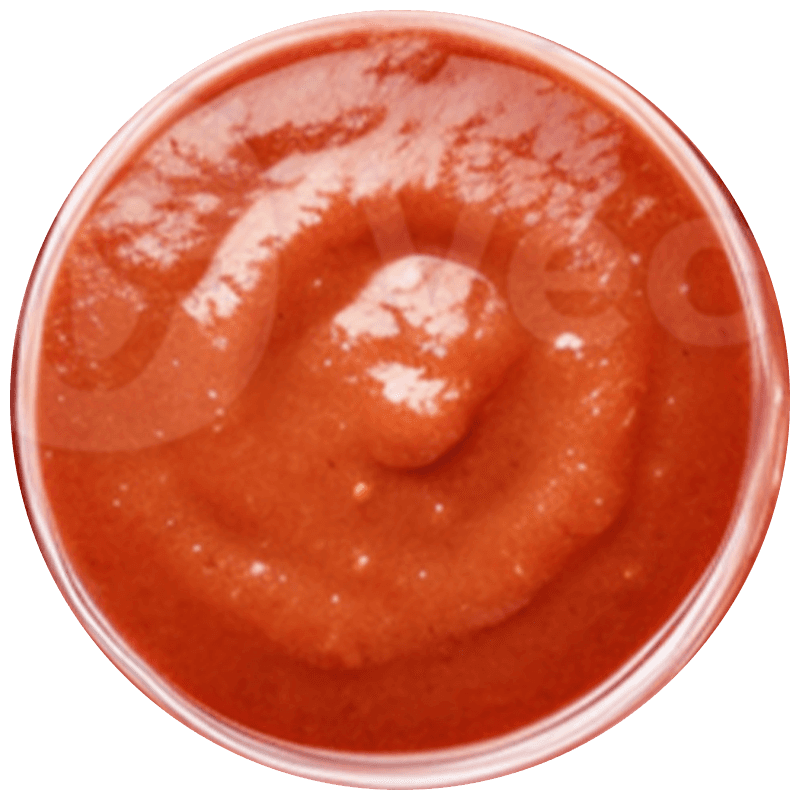 A bright, modern dining room featuring a long light wood table set with several matching wooden chairs and white cushions, illuminated by natural light streaming through large windows overlooking a lush green and sunlit yard.