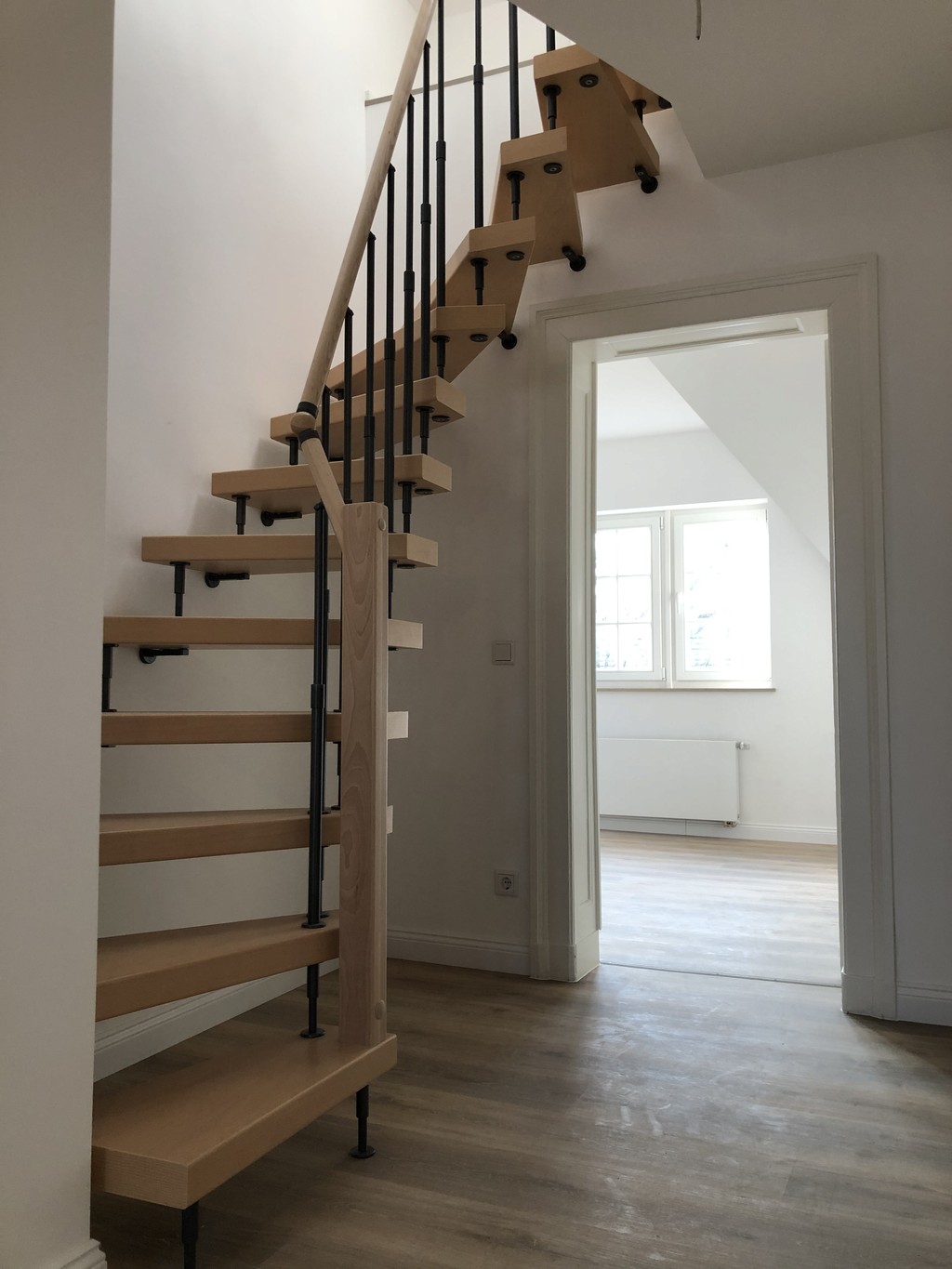 Neu gebaute Wendeltreppe im sanierten Mehrfamilienhaus Regerstraße als moderne Verbindung zwischen den Stockwerken
