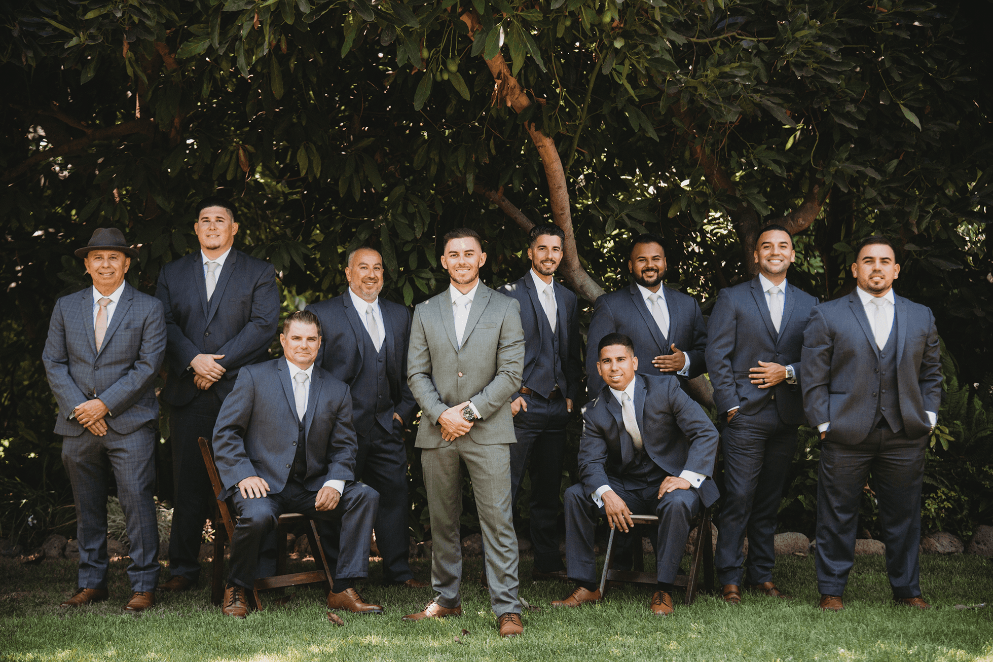 Editorial groomsmen portrait with avocado trees blocking the sun behind them