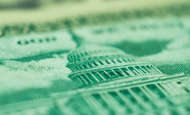 Close-up of crumpled U.S. dollar bills, showcasing green hues and intricate paper textures.