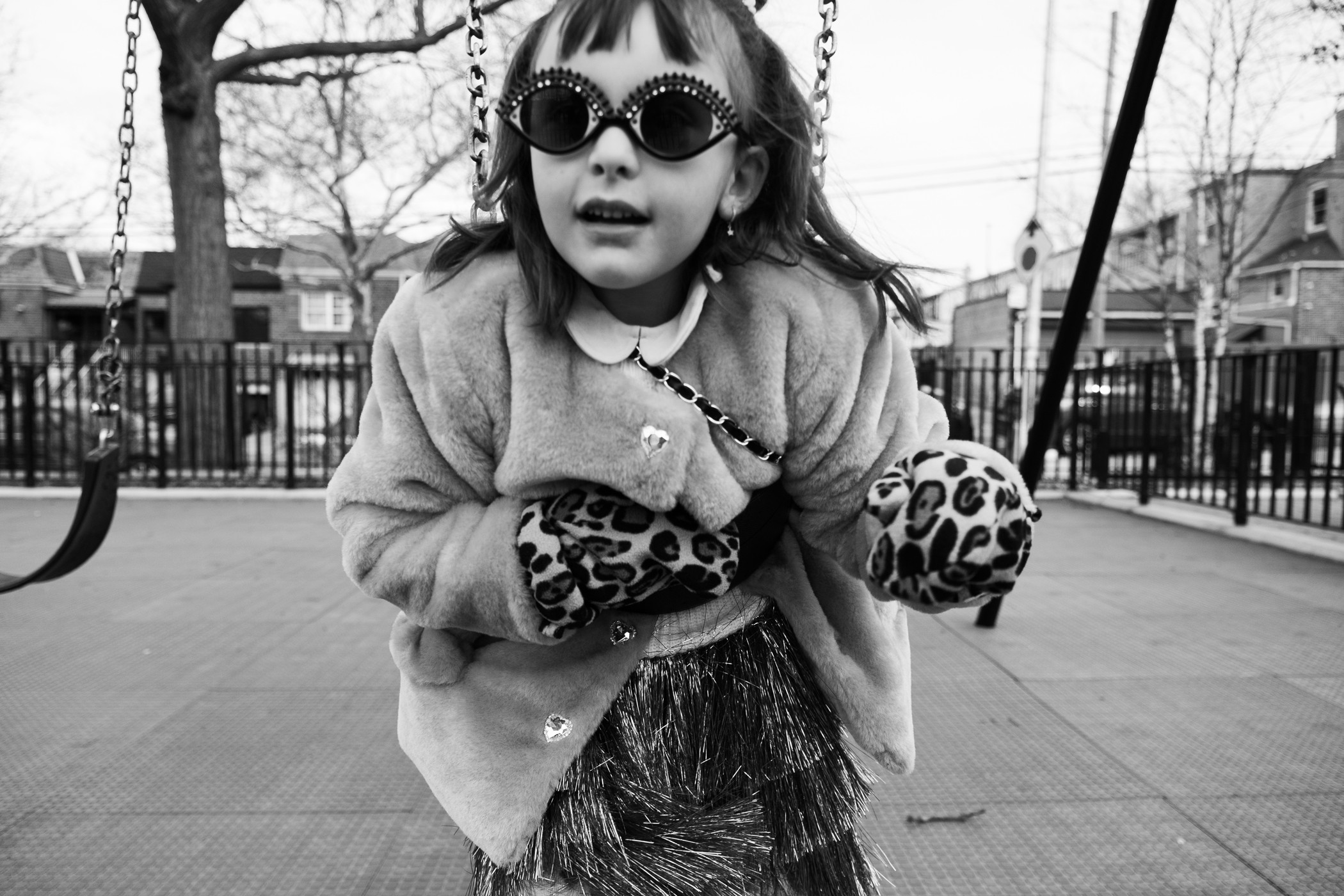 katt-jones-candid-child-swinging-portrait-new-york-city-street-photography