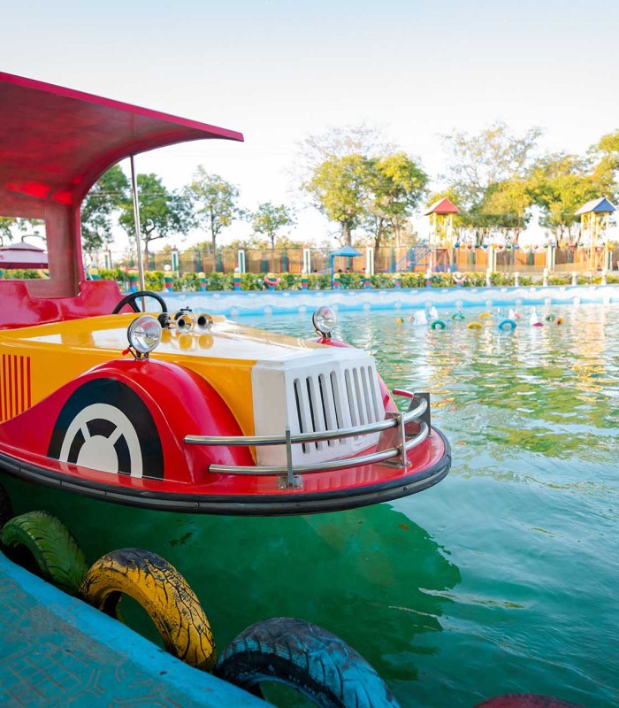 Sunlit orange chair on wooden floor near staircase.