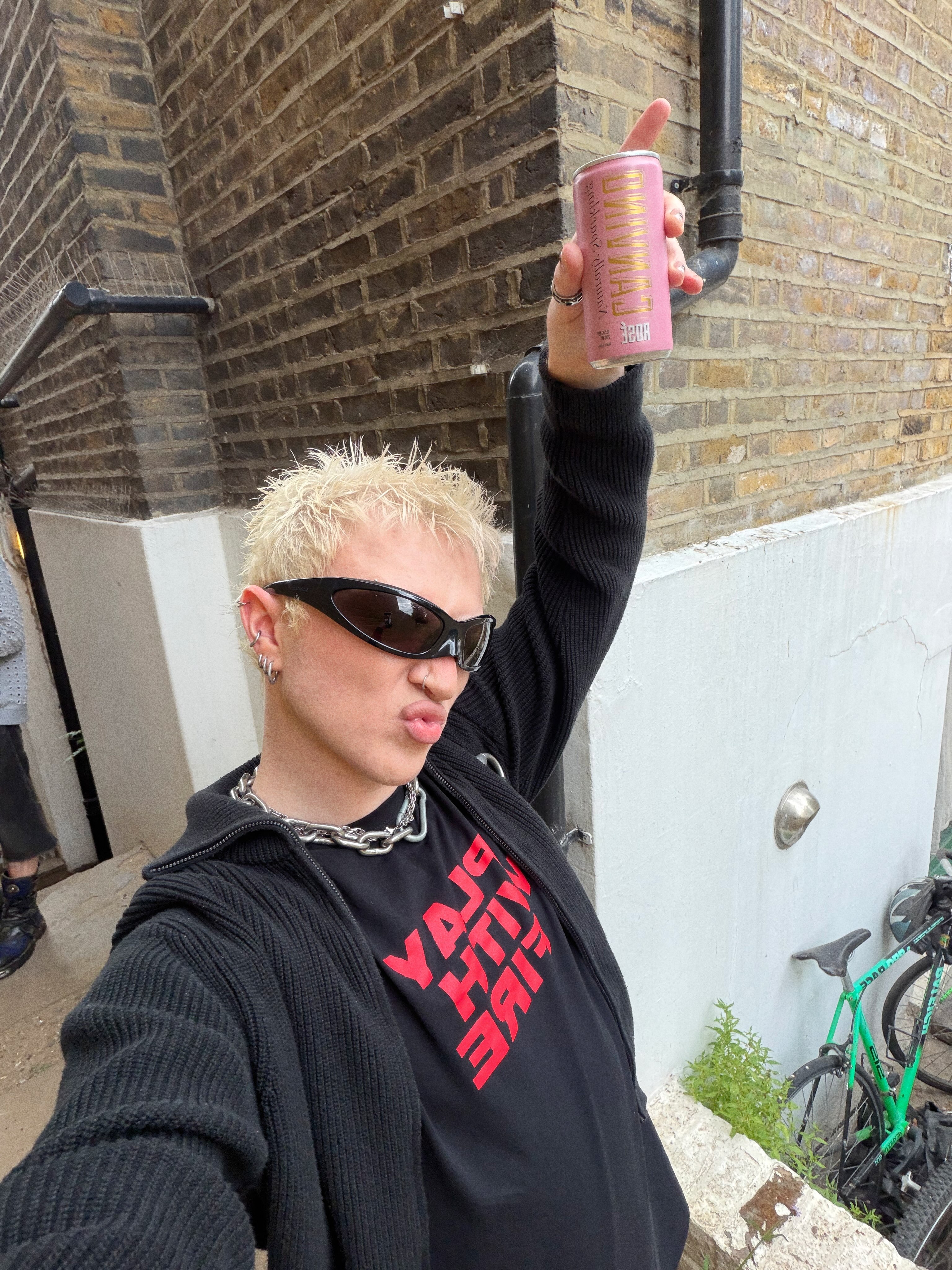 Bo Quinn outdoors in sunglasses and a black sweatshirt between transformations
