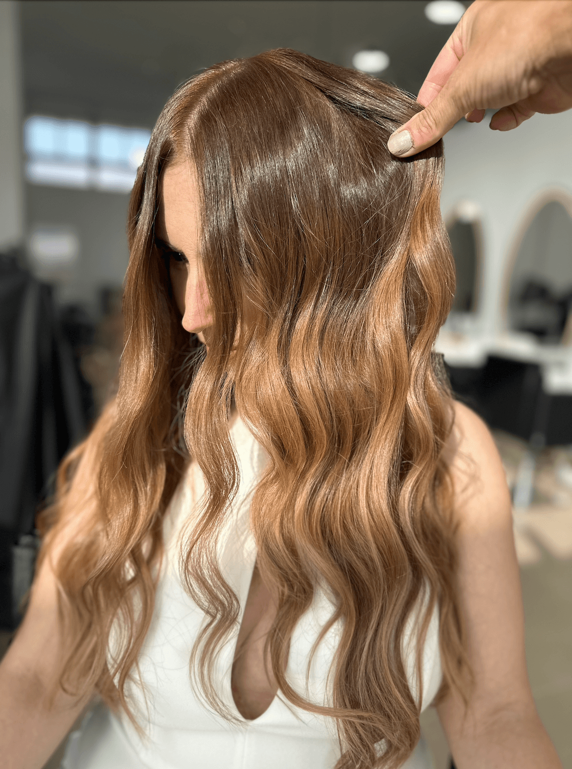 a woman getting her hair cut by a hair stylist