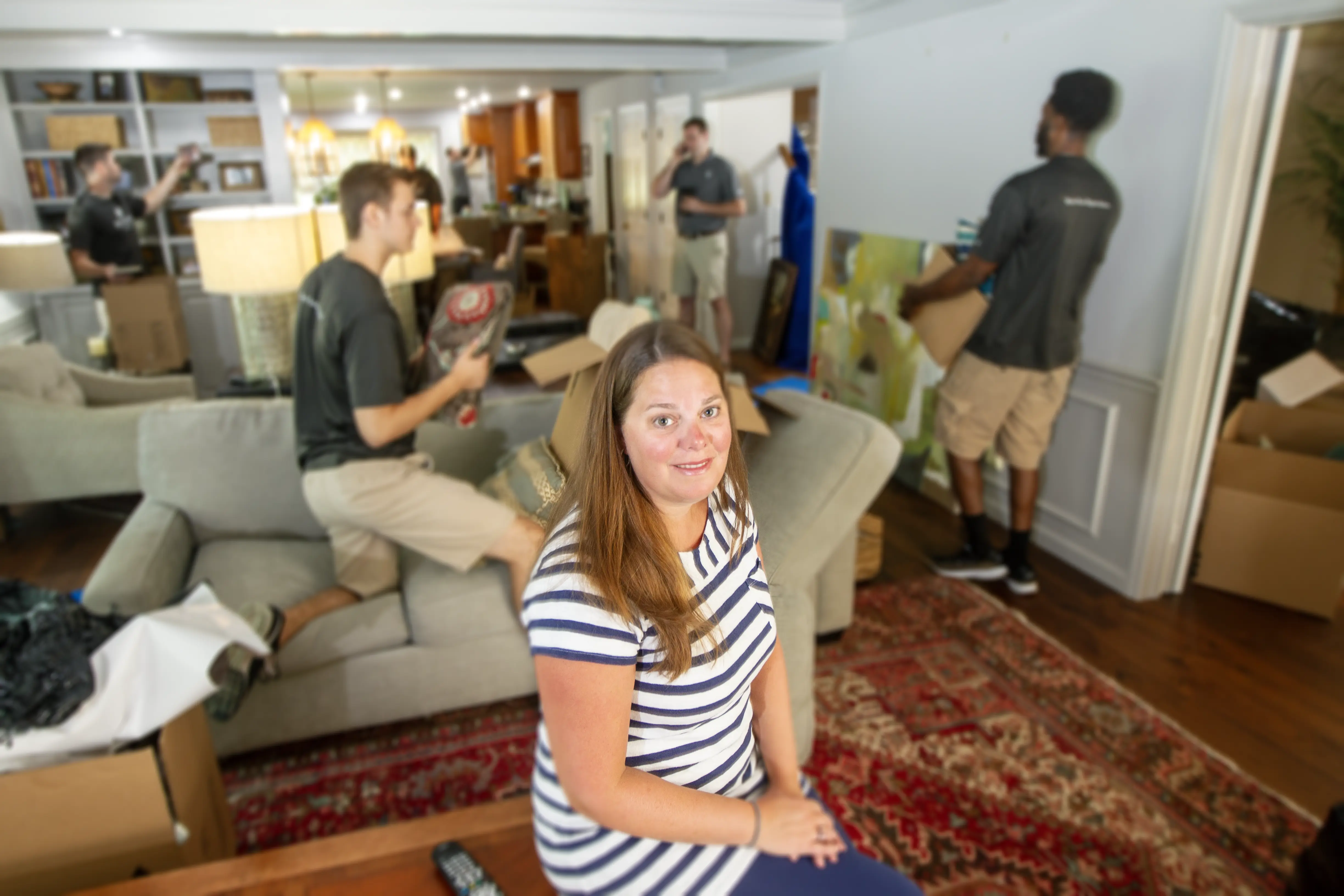 Renew Moving & Packing crew carefully packing and organizing residential fine art and custom furniture during a local Birmingham move.