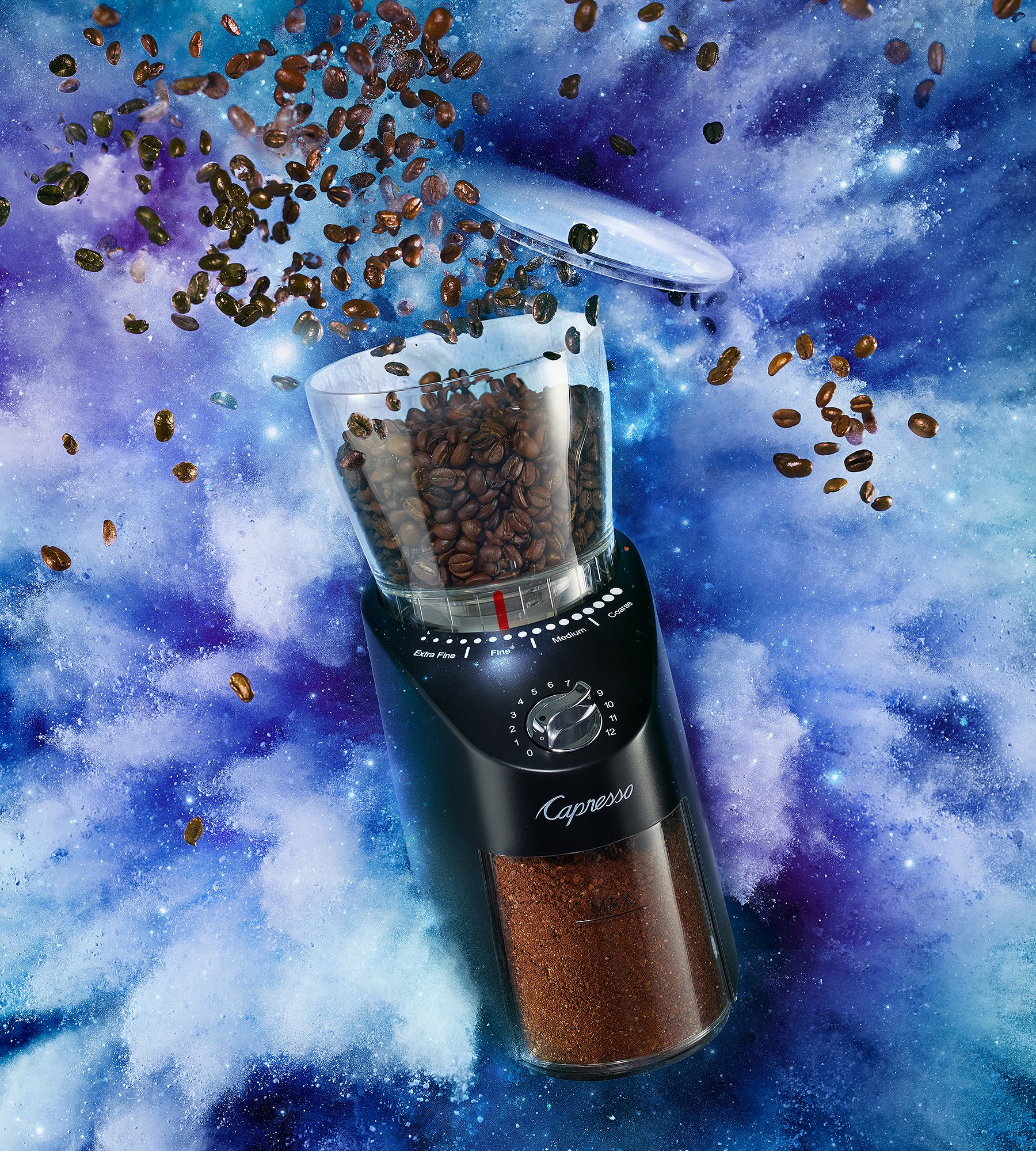 A coffee bean grinder with coffee beans exploding out of its lid with a burst of purple and blue cloud coming from behind.