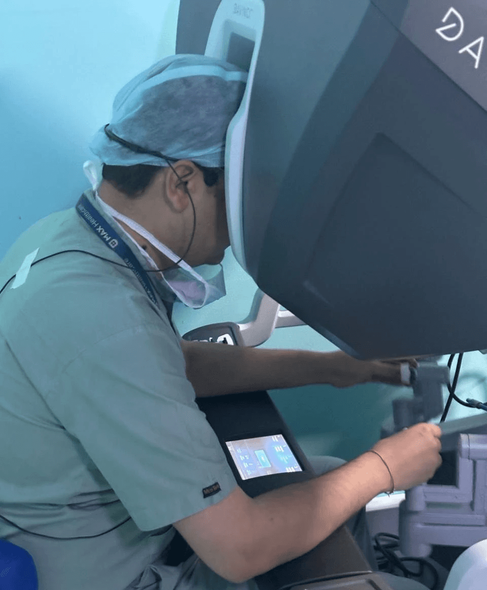 Dr. Tushar operating the robotic console while instruments perform precise surgical movements.