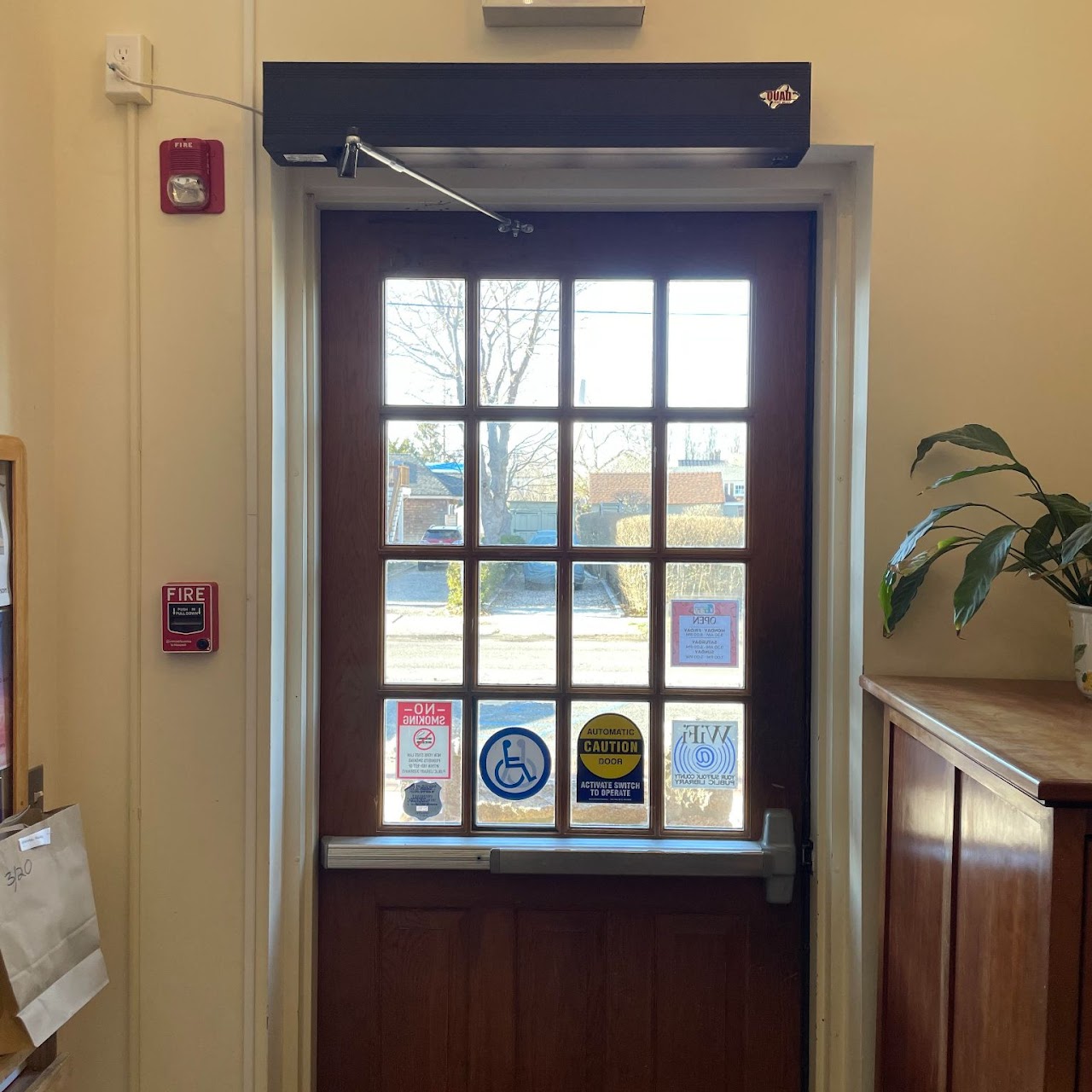 Repaired commercial entry door with new automatic closer and trim