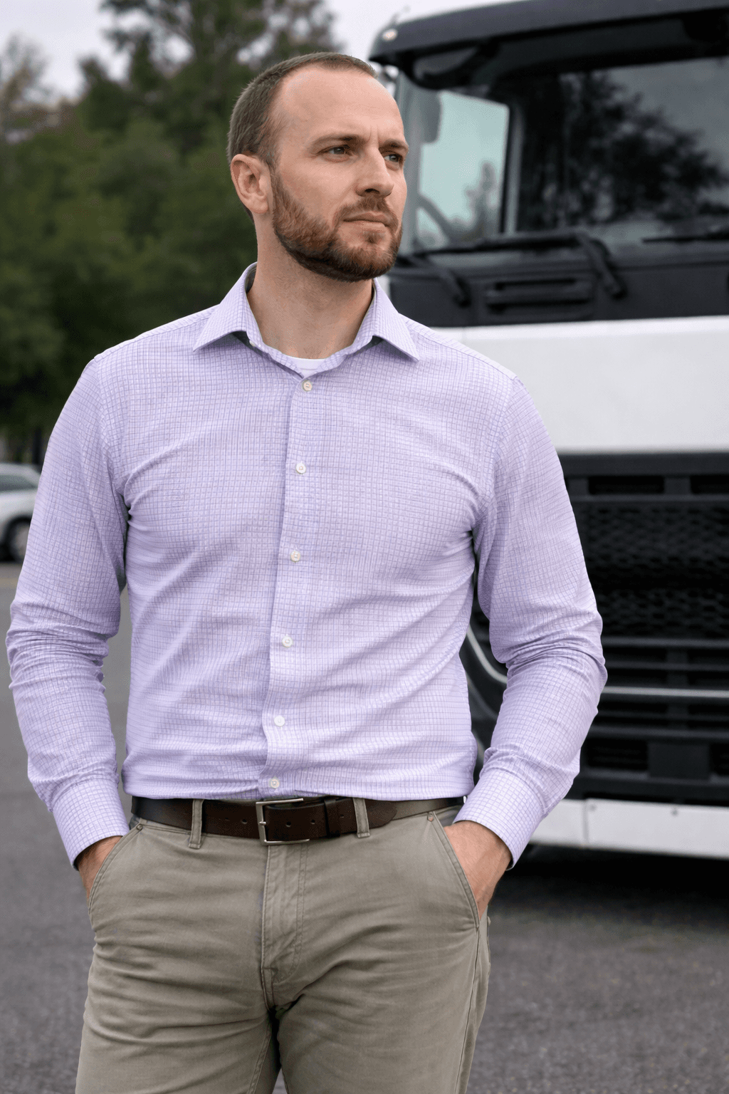 Side profile of a person wearing a red cap and yellow glasses against a red background.