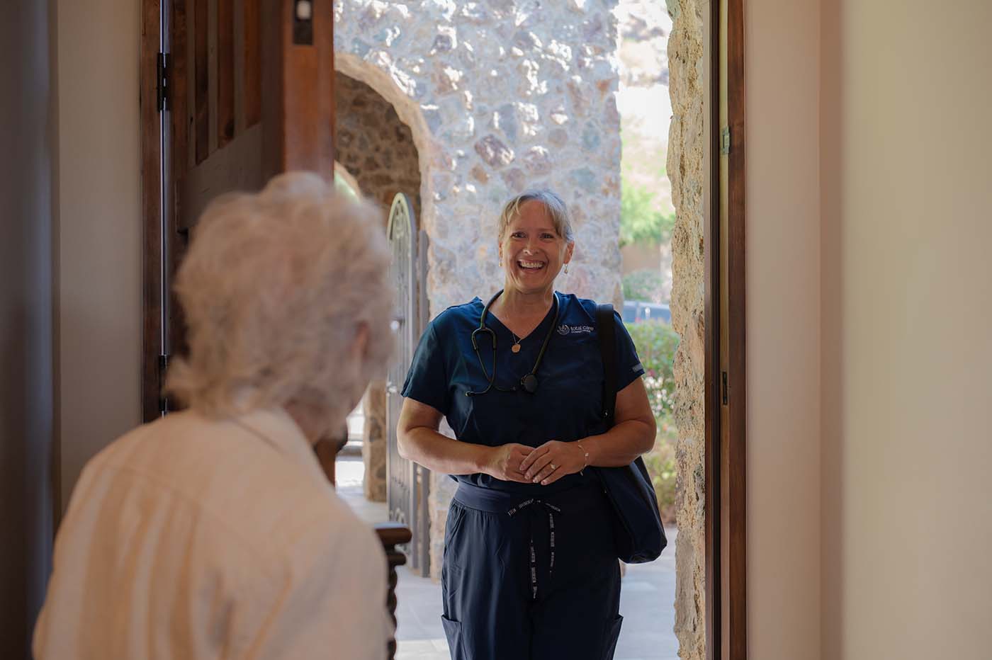 Careworker arriving at home with a big smile on her face