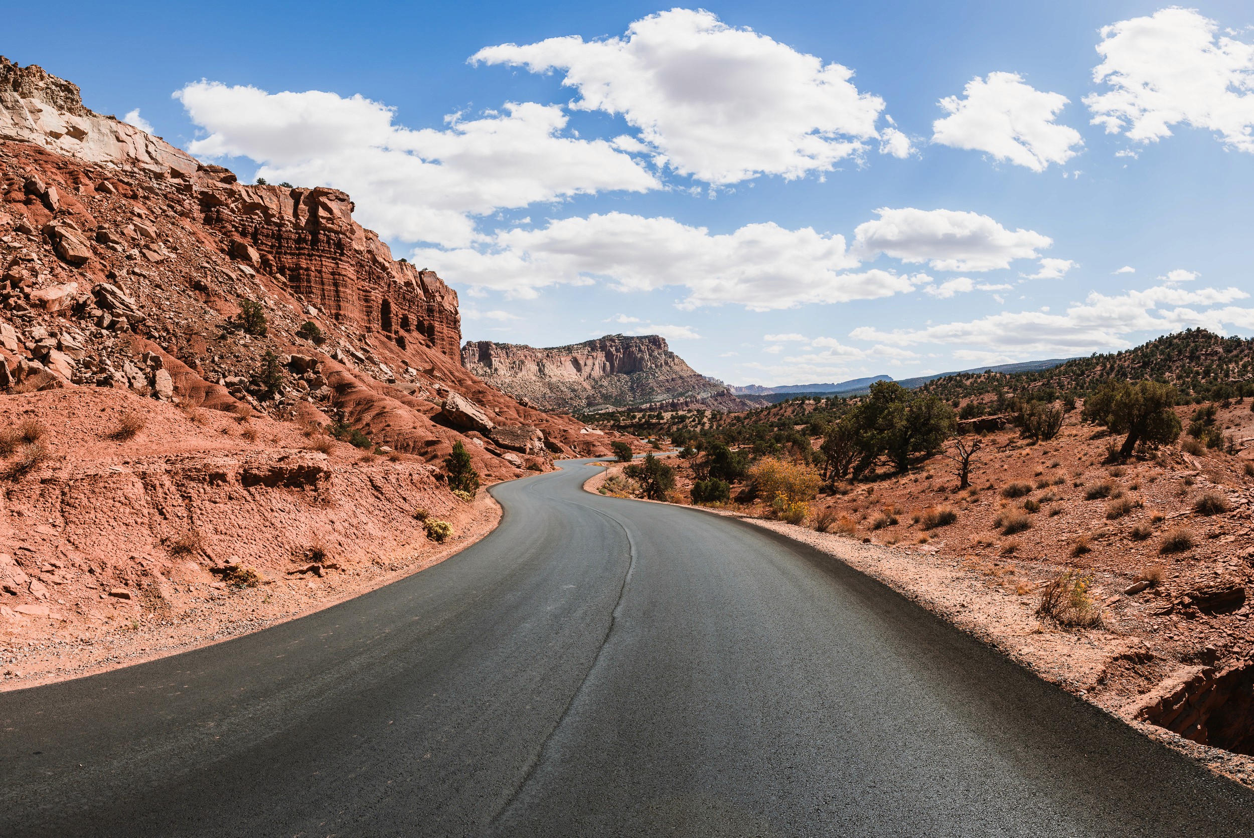 A winding roadway through the blue sky during a roadtrip through Capitol Reef National Park, Utah