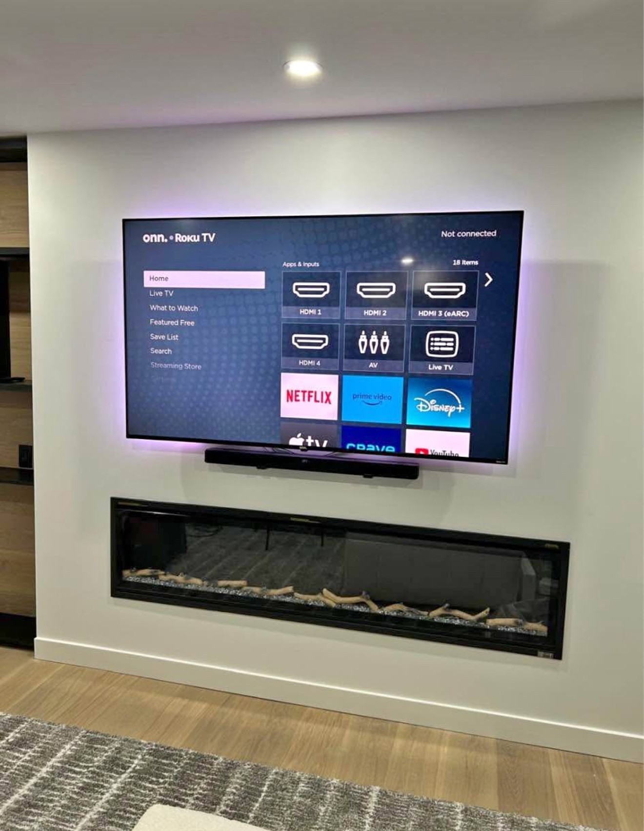 85-inch TV mounted using a above console setup in a residential home in Orlando, with clean wiring and a modern look.