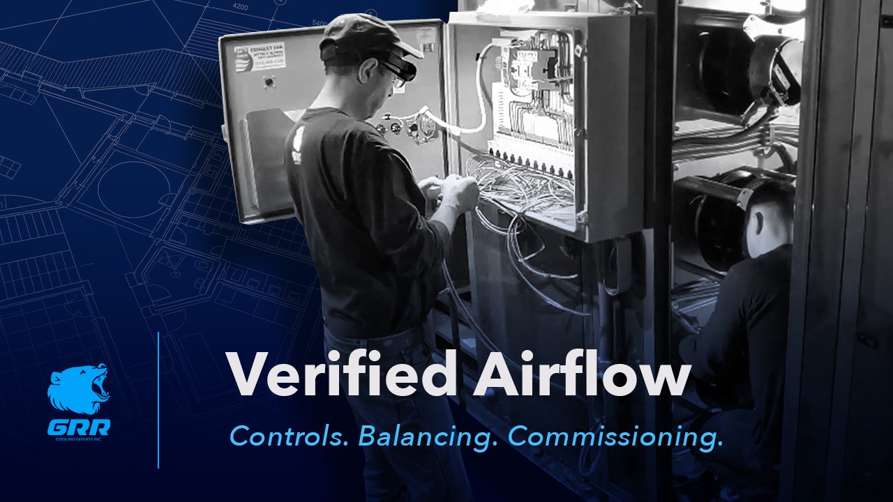 GRR technician commissioning control panel during HVAC retrofit with EC fan array in NYC building