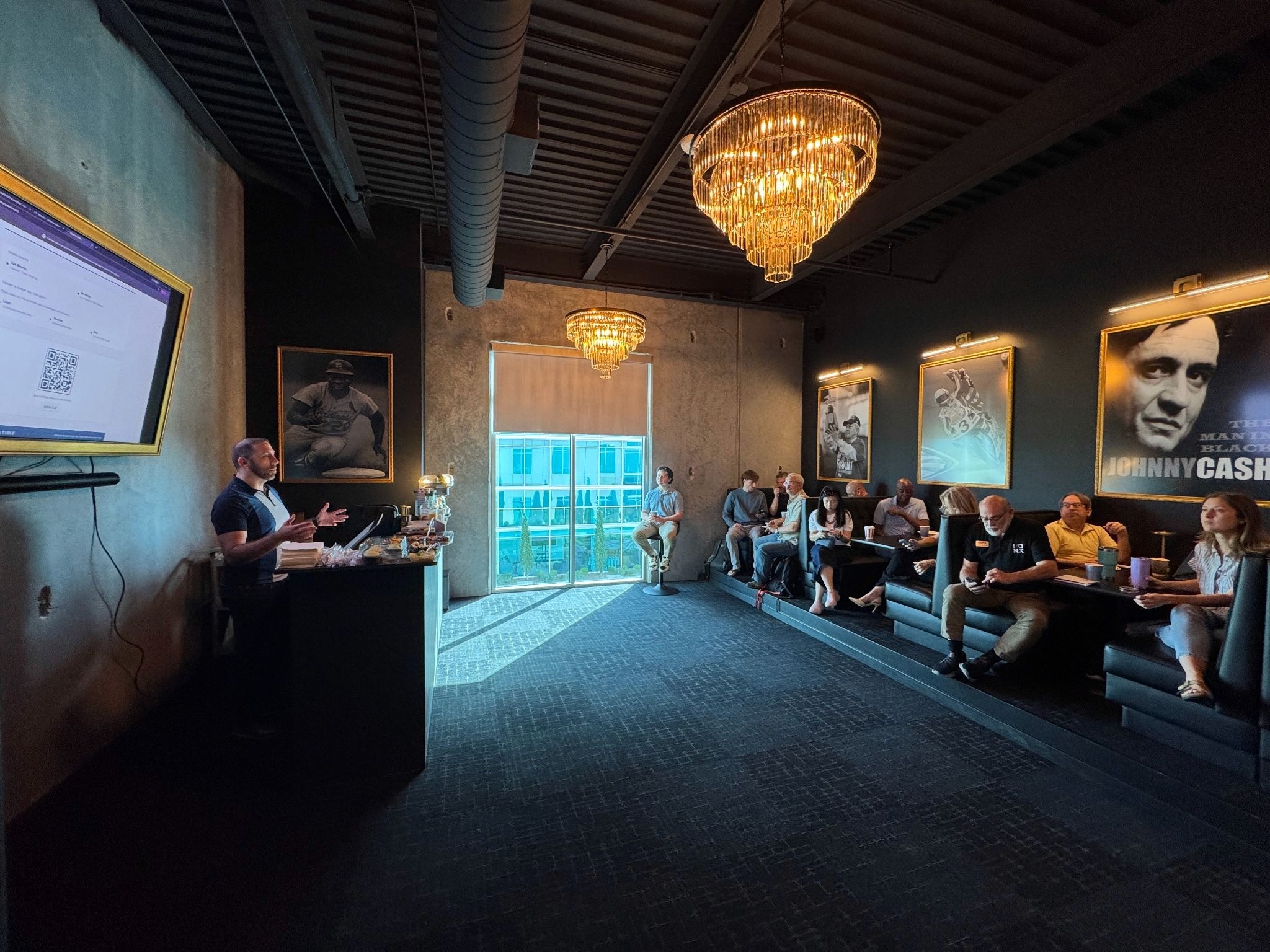 Presenter leading a Triton Ventures workshop for attendees in a modern conference room.