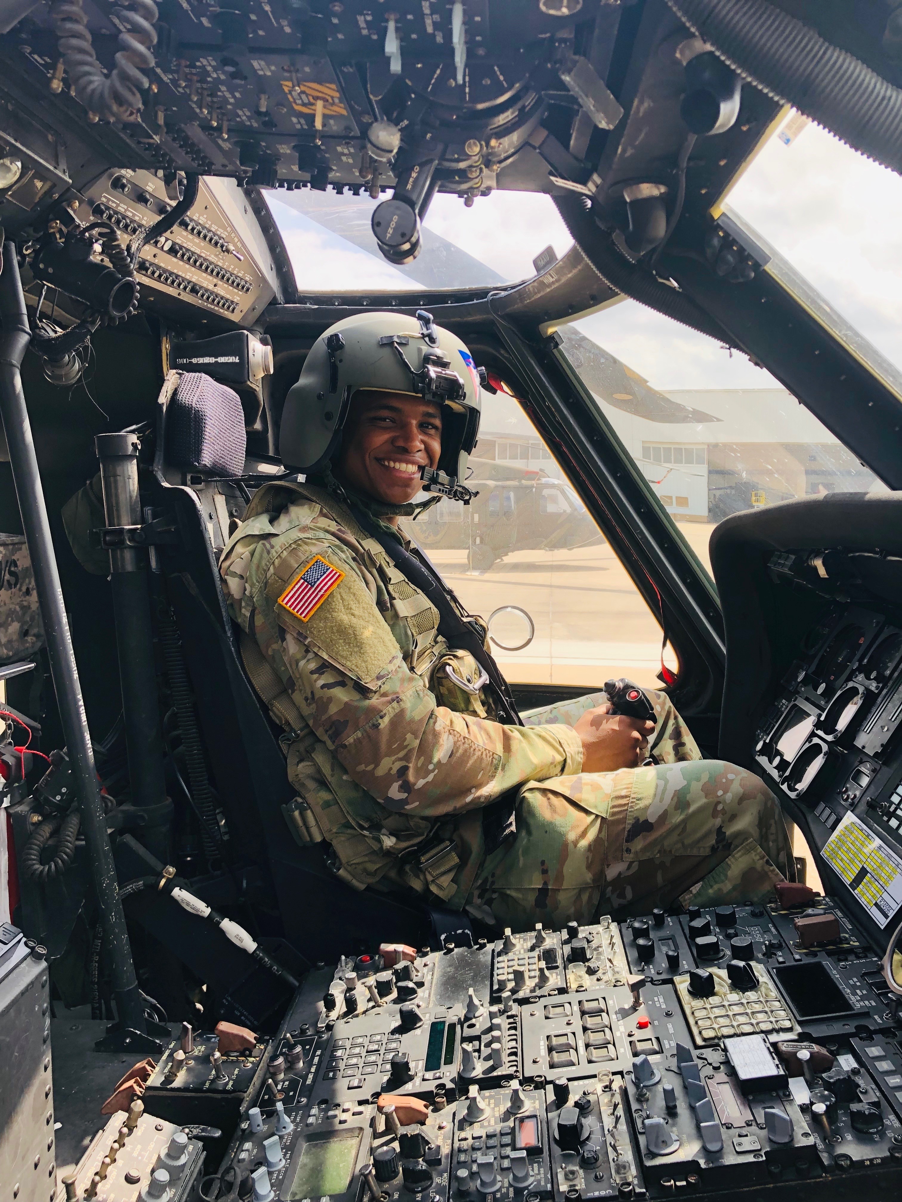 Christopher Busby, founder and owner of Rapid Glass in Austin, Texas, sitting in the cockpit of a Black Hawk helicopter in Army Reserve uniform, highlighting his dedication to innovation and service. With nearly 10 years of military experience, Christopher brings his passion for technology and smart glass solutions to homes and businesses in Austin.