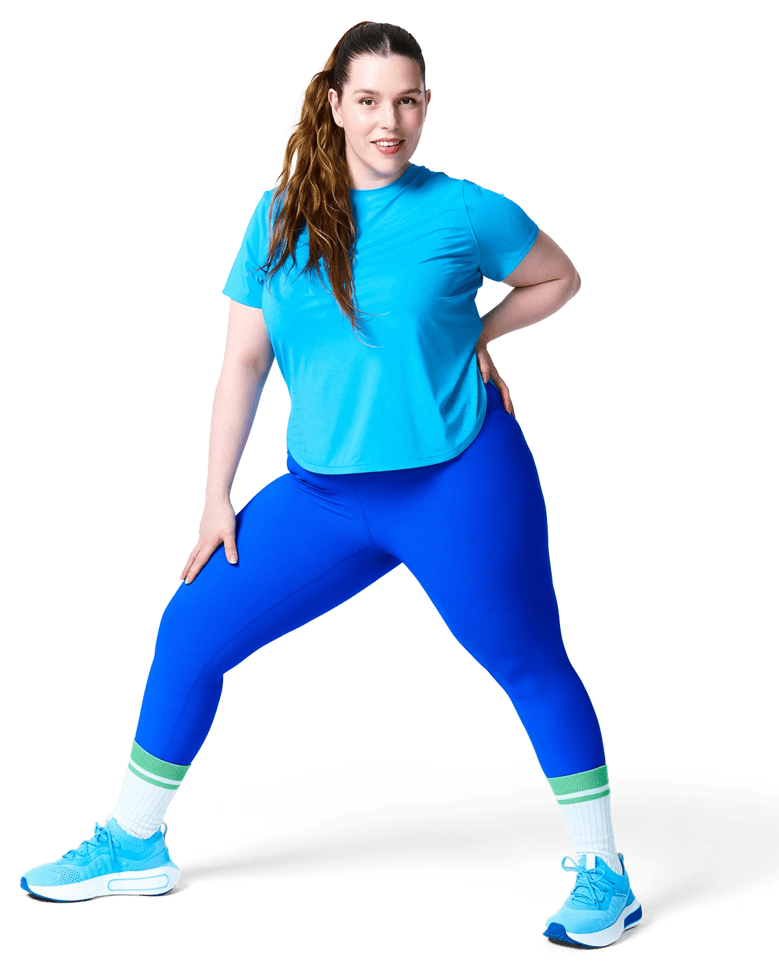 A person in sportswear is lifting one knee while standing on one leg, showcasing a workout or stretching activity.