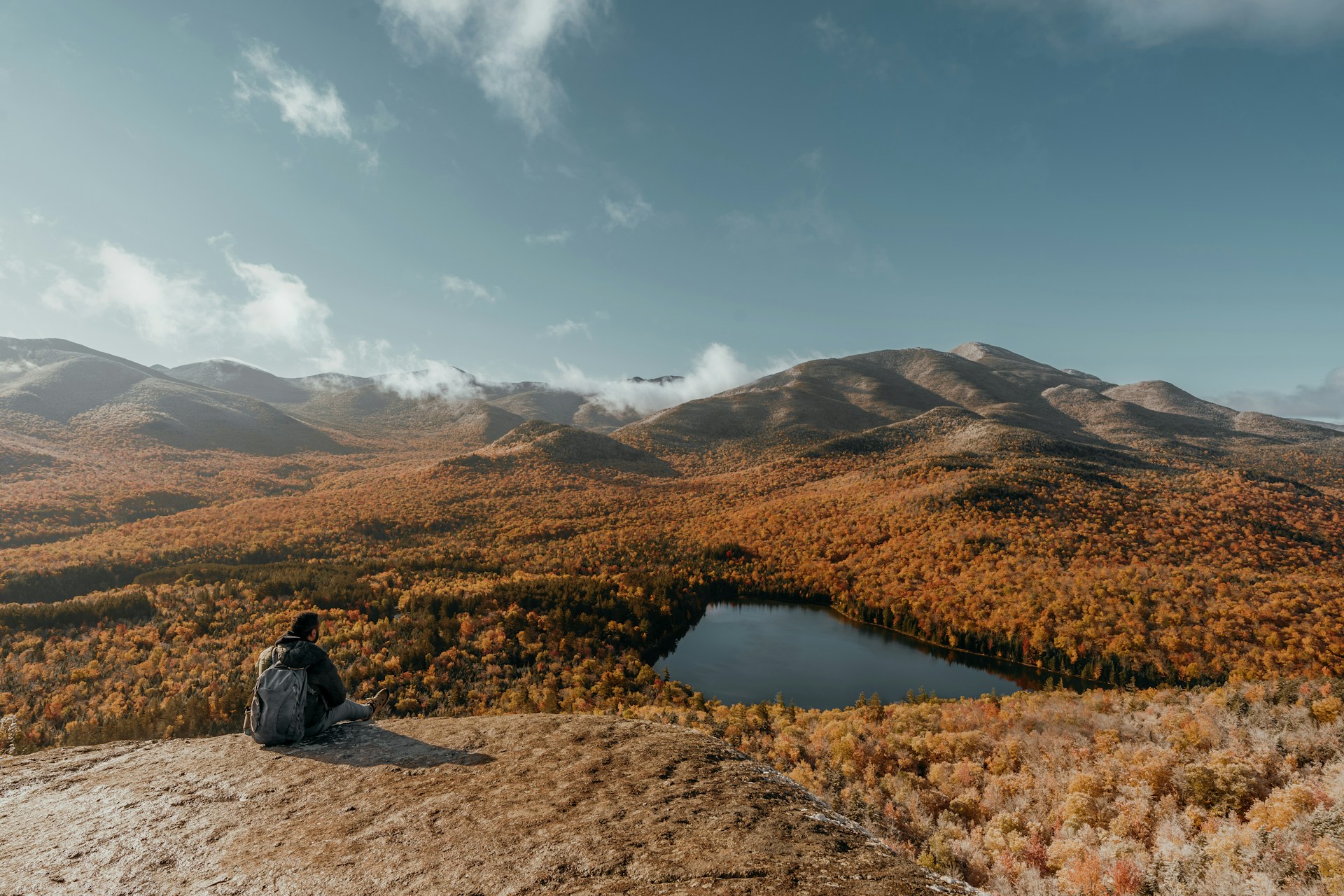 Two people admire a misty mountain landscape view.