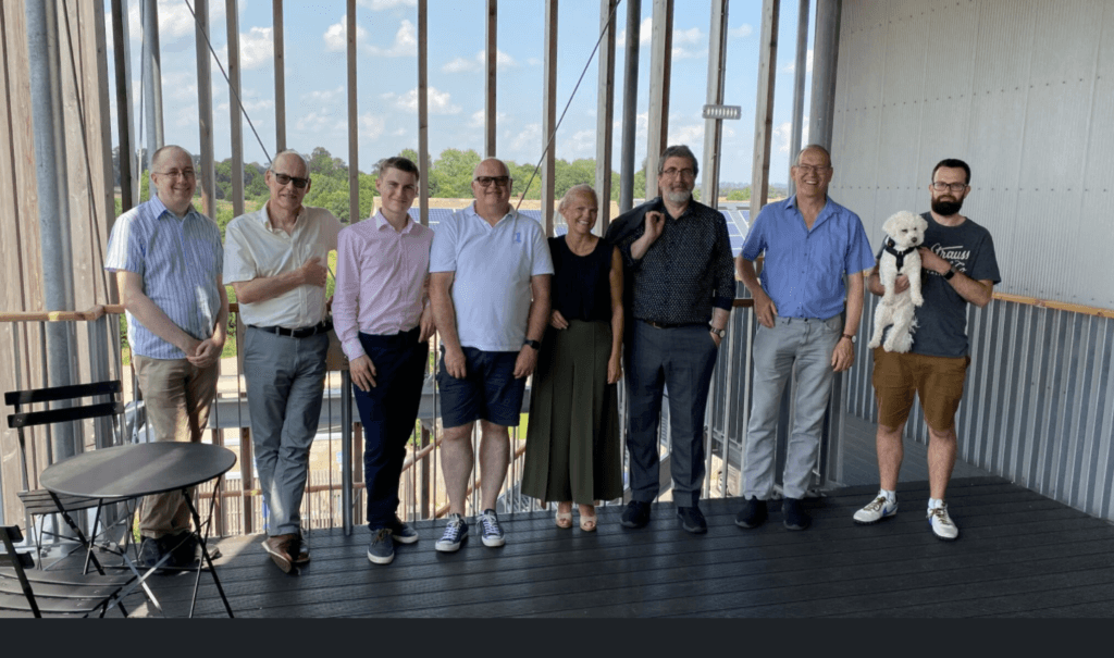 The re-universe team standing together on a balcony, August 2021