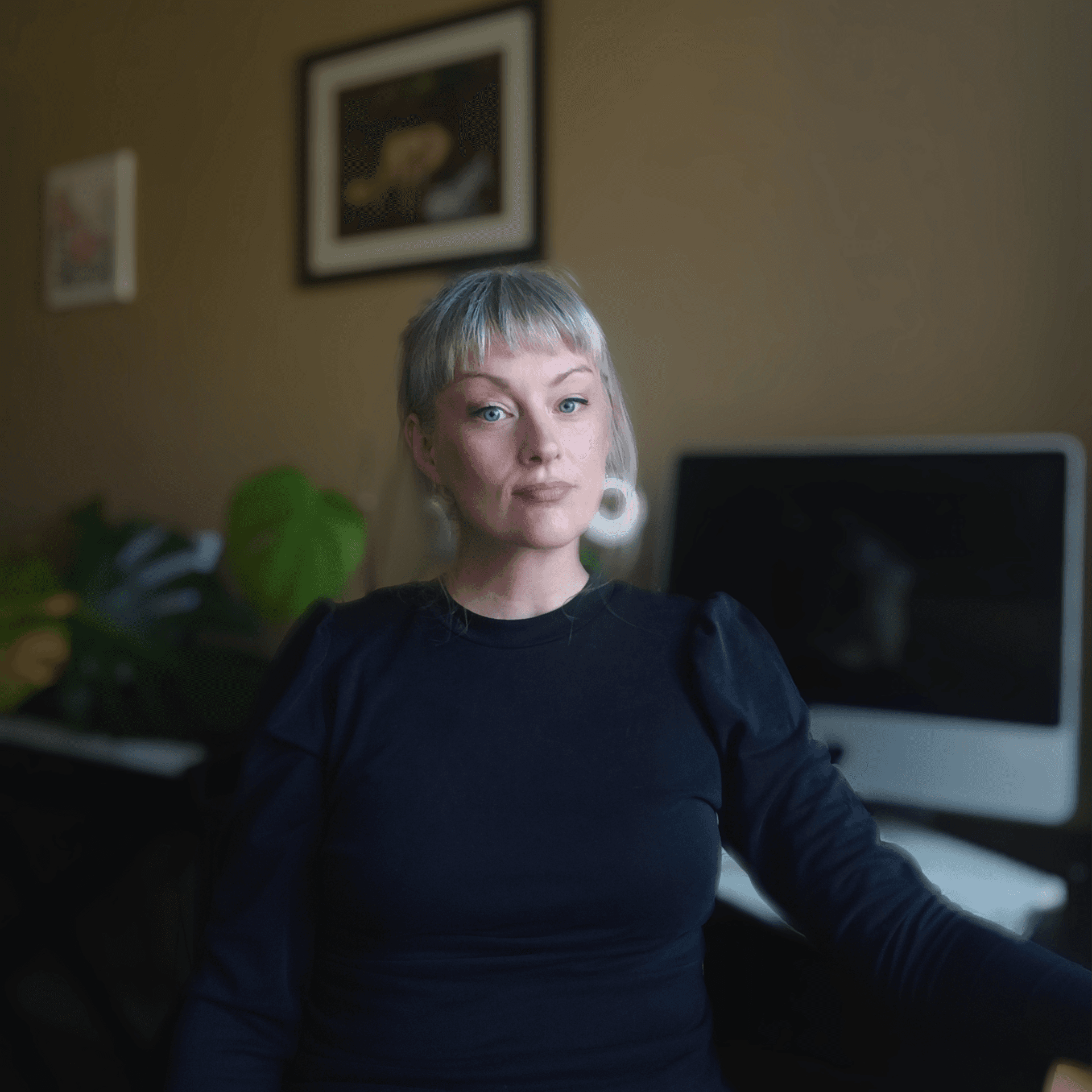 woman using MacBook and wearing yellow headphones