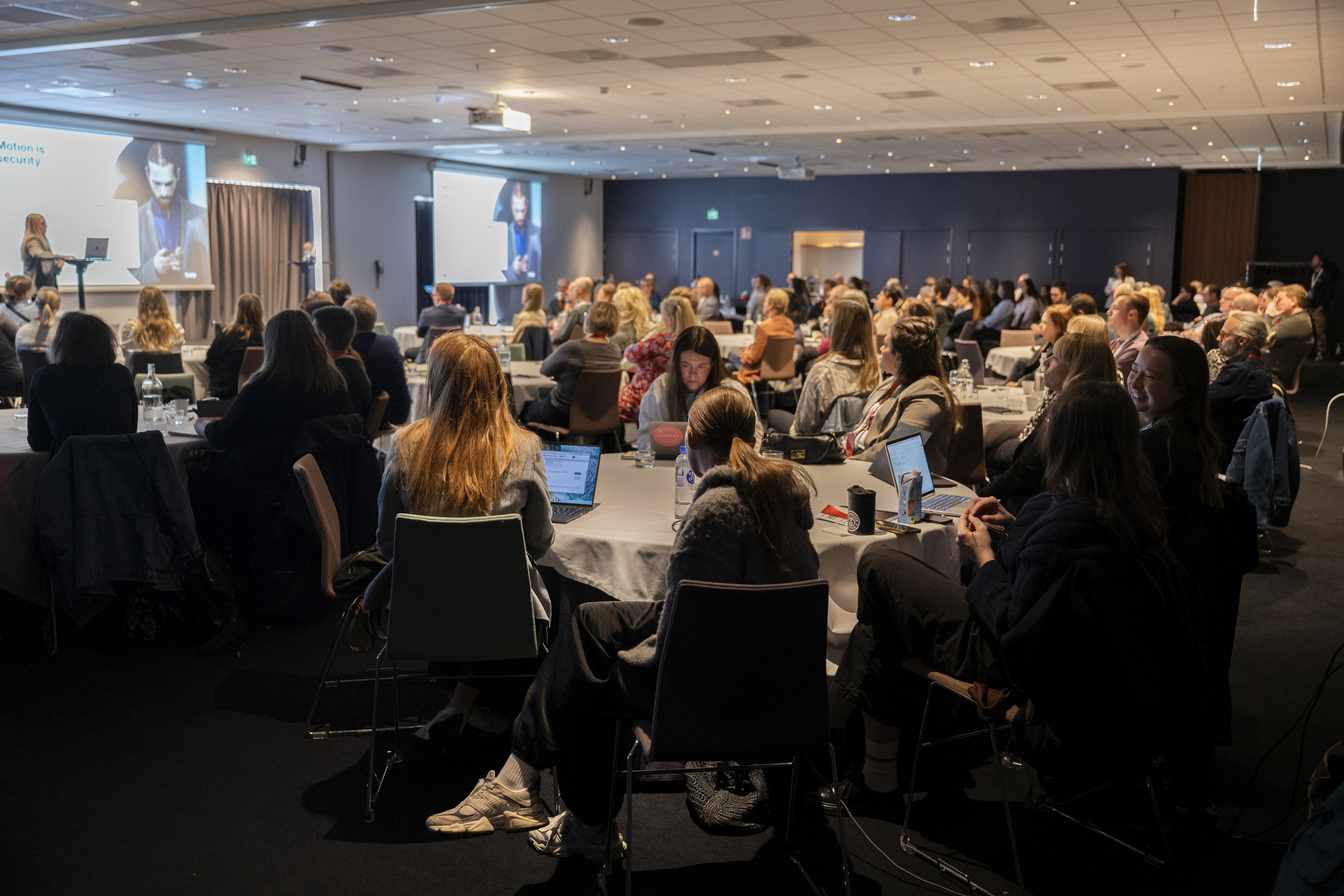 Audience members during a presentation about Secure wallet