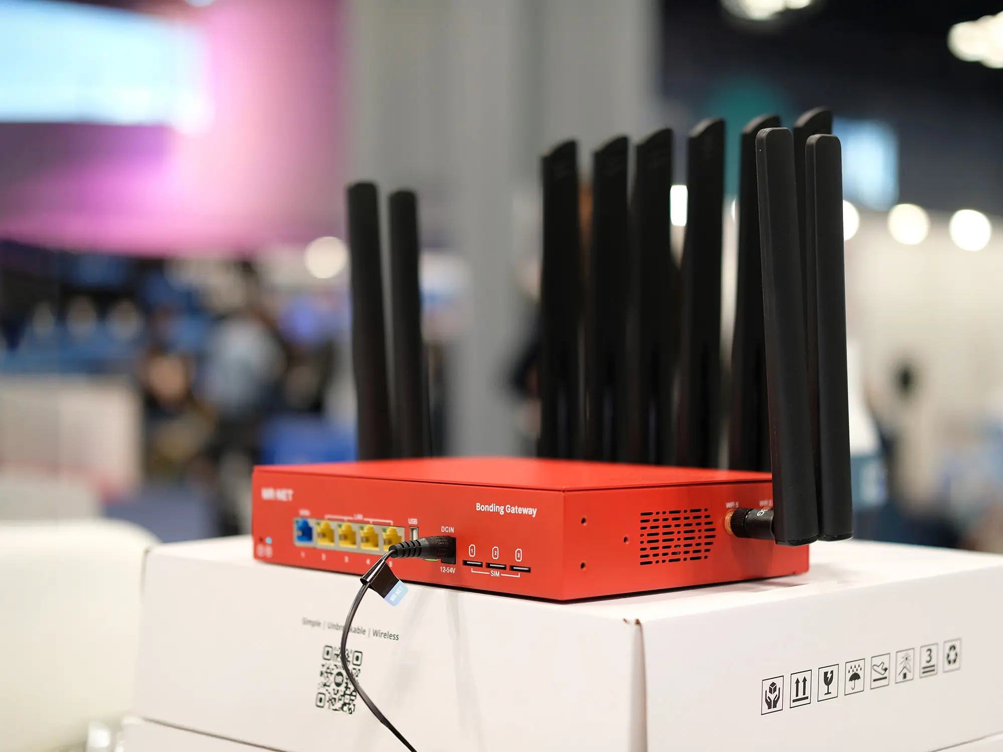 Busy trade show floor with packed exhibitor booths and attendees, highlighting crowded convention center environment