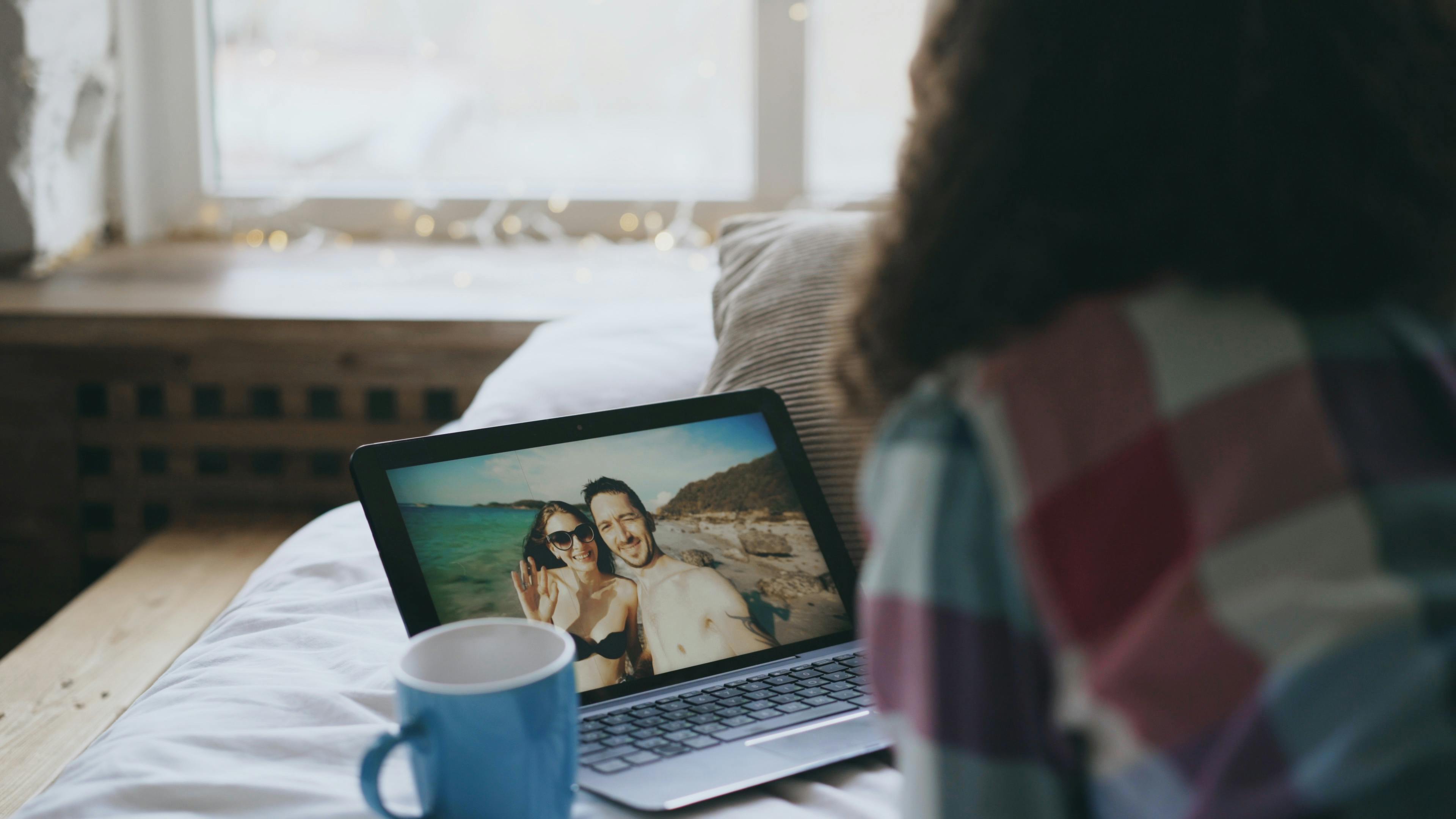 girlfriend looking at her laptop in the bed