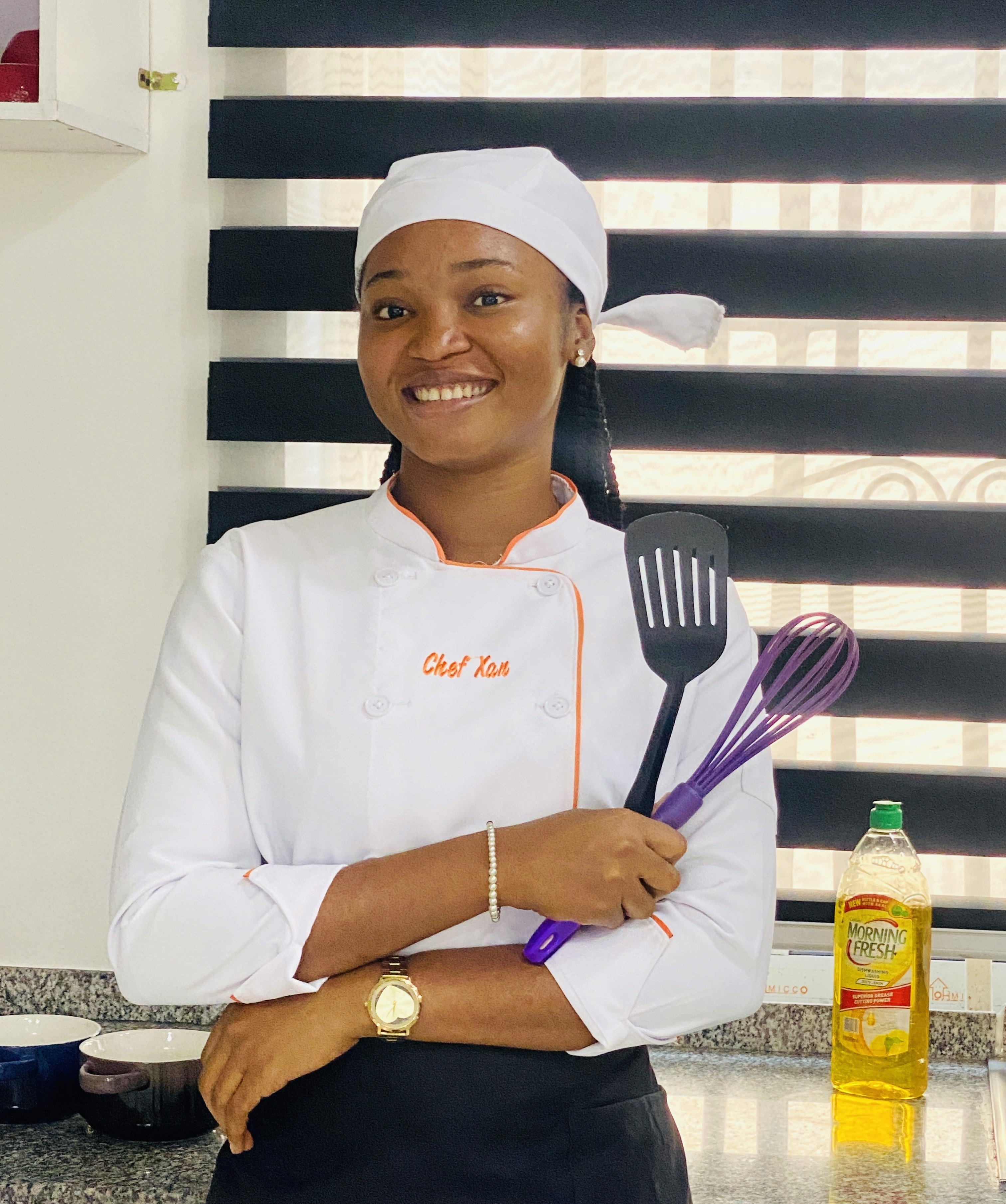 Chef Xan holding spatulas