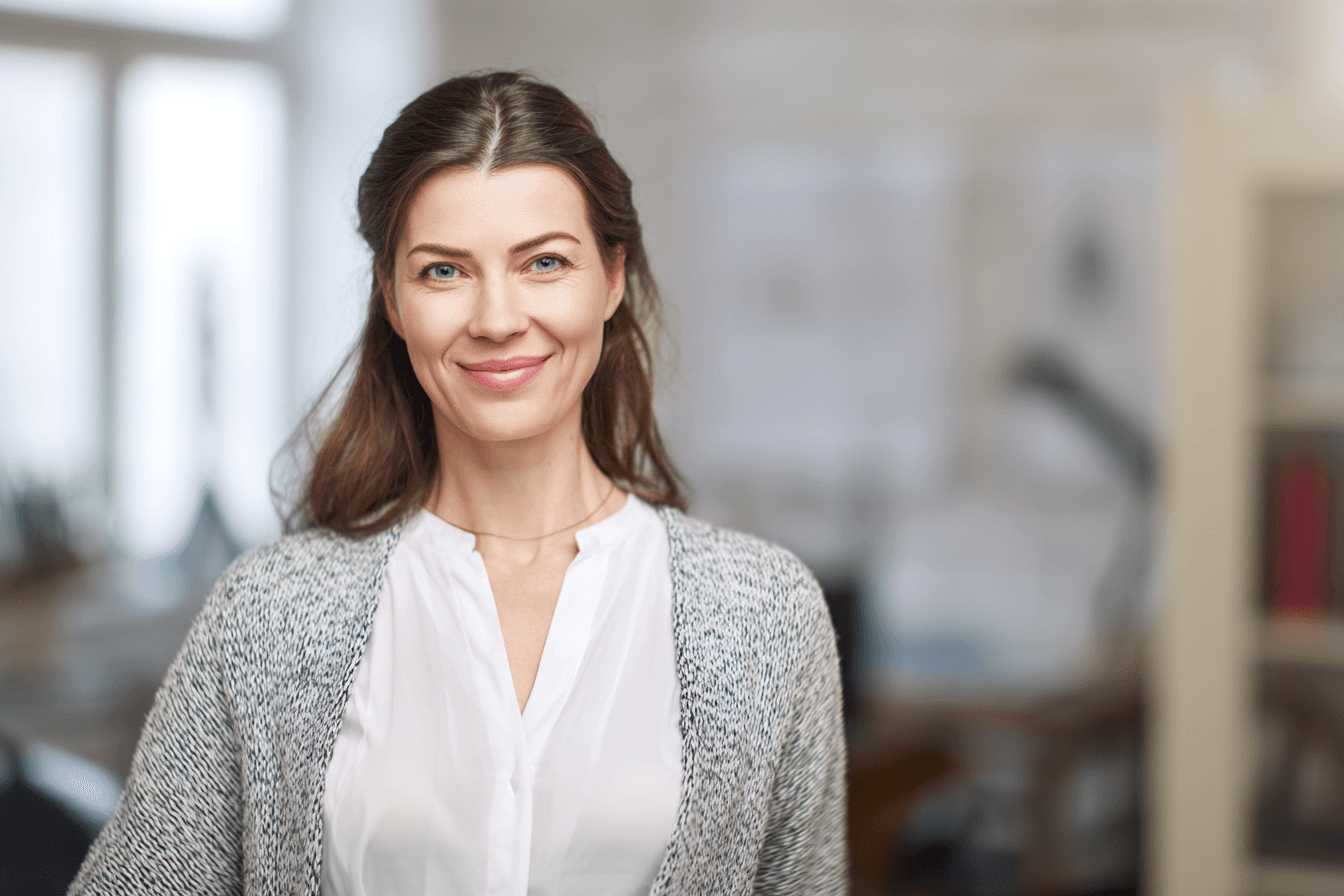 Woman smiling at camera in office setting