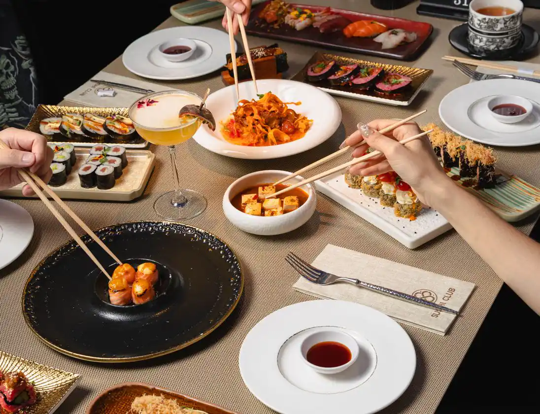 A table of guests sharing dishes from the all-you-can-eat menu