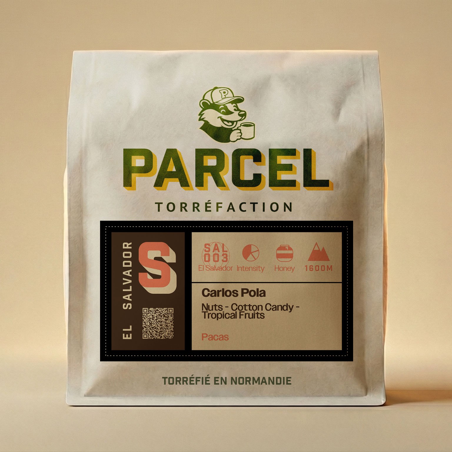 Parcel Torréfaction El Salvador Carlos Pola coffee bag showing tasting notes of nuts, cotton candy, and tropical fruits using Pacas varietal, shown in sharp focus for product image accessibility.