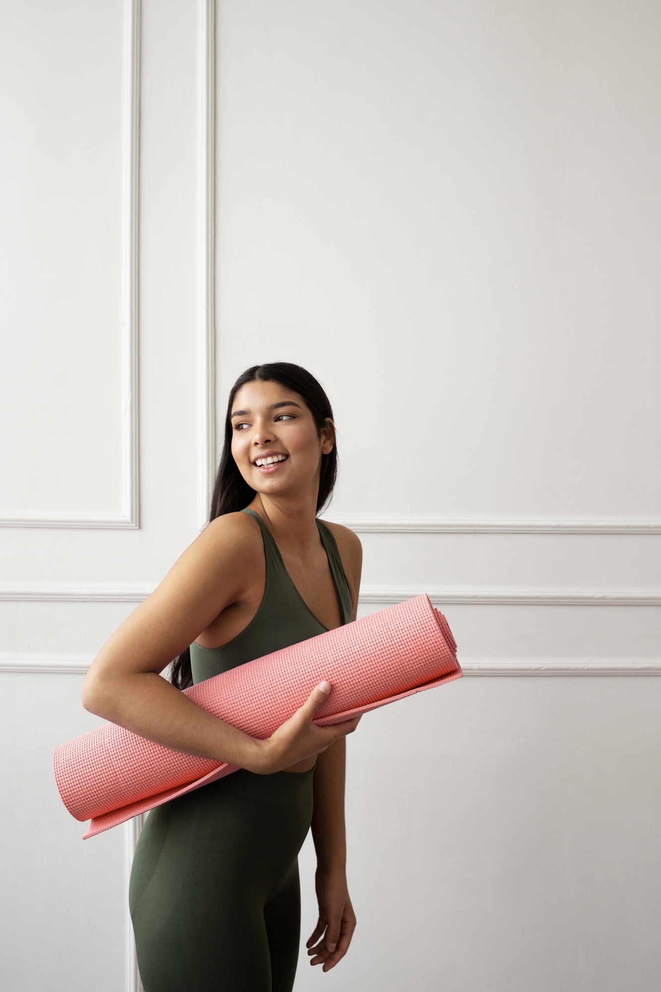 woman holding a pink mat