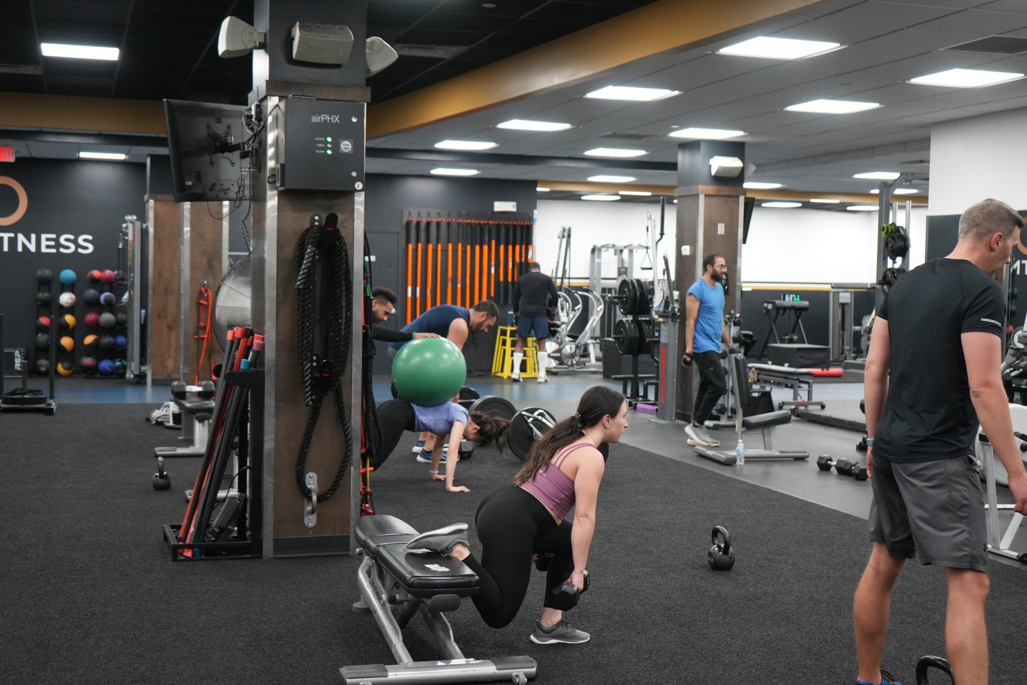 a woman is doing a piyoma exercise in a gym
