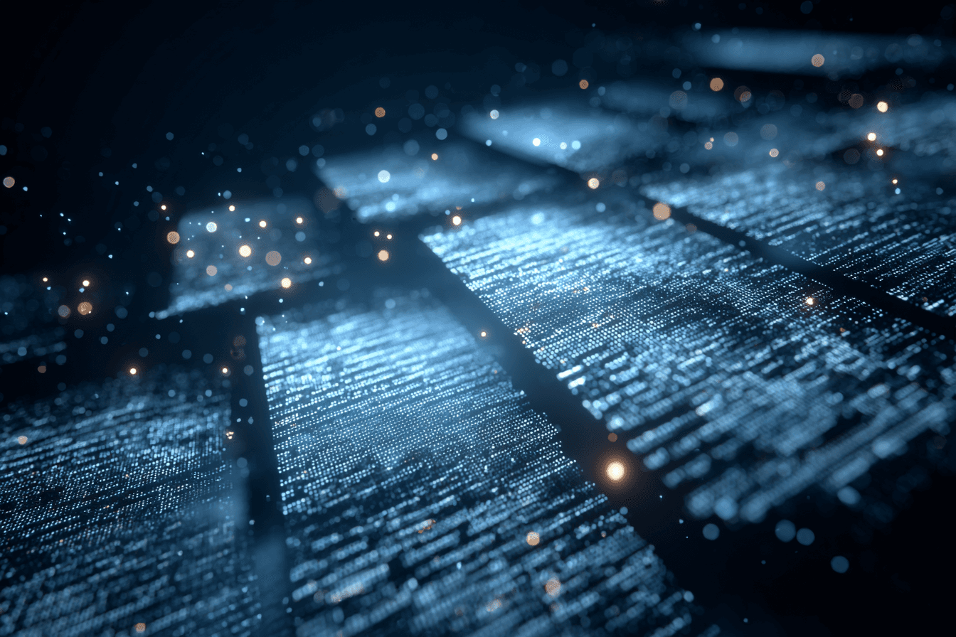 Two men discuss a project while standing at a laptop in an office.