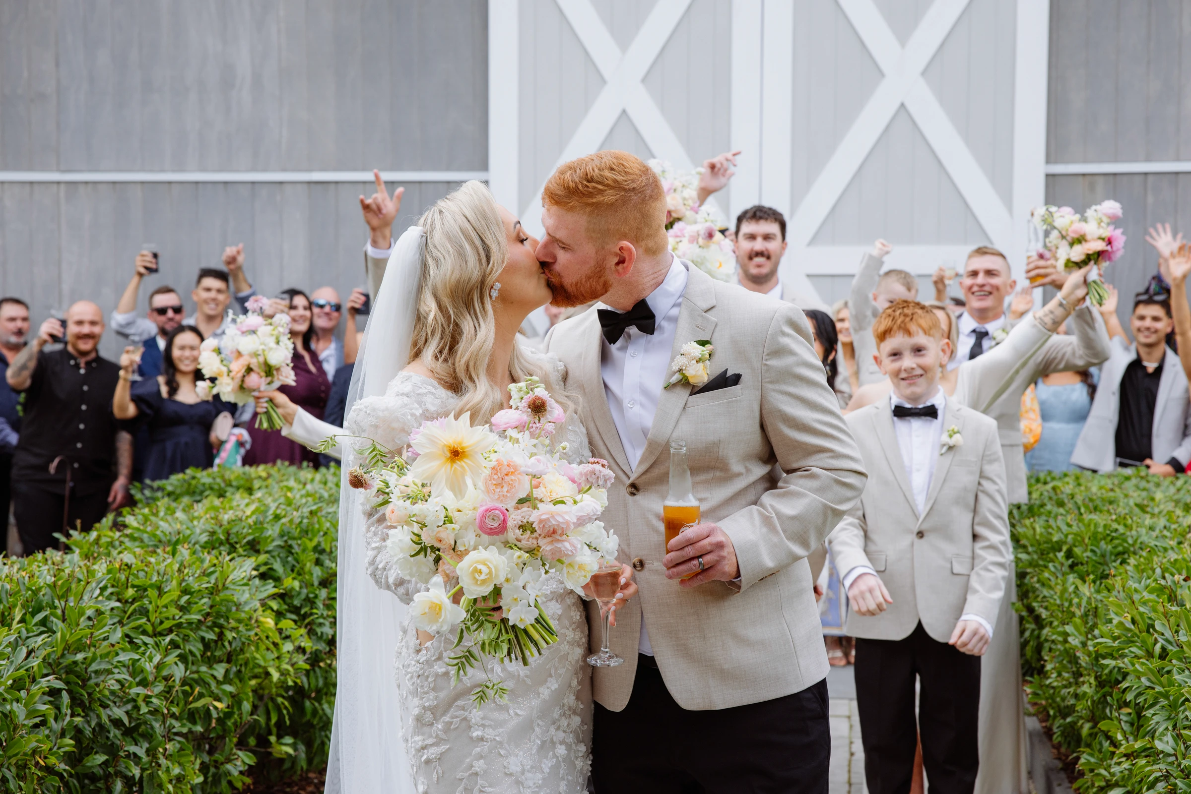 Bride and groom looking into each other's eyes in front of pool