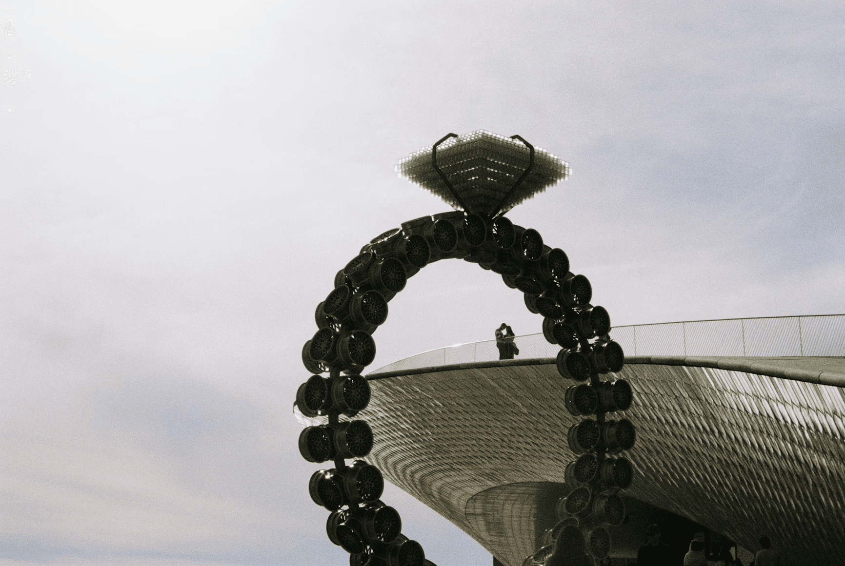 A large metal sculpture with a sky background