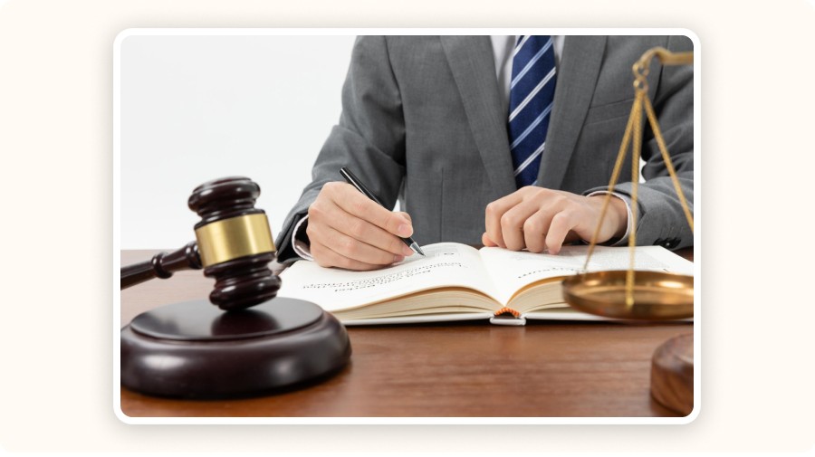 Man writing in notebook in front of a gavel
