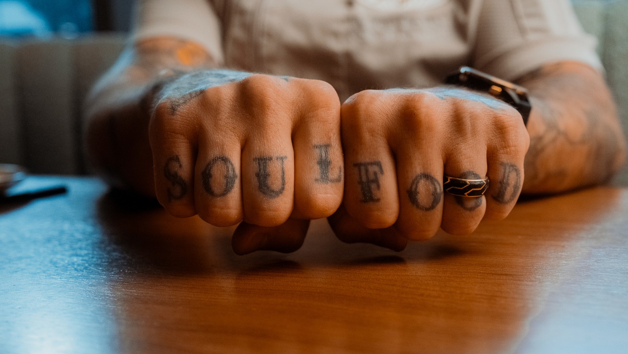 the knuckles of a chef that has the words soul food tattood across