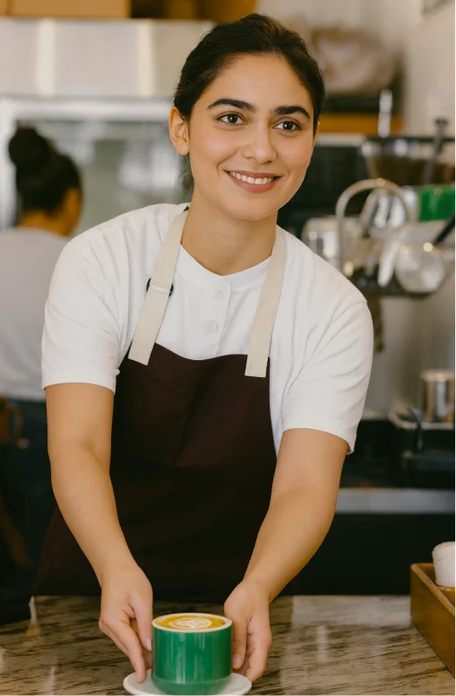 Female barista holding coffee cup