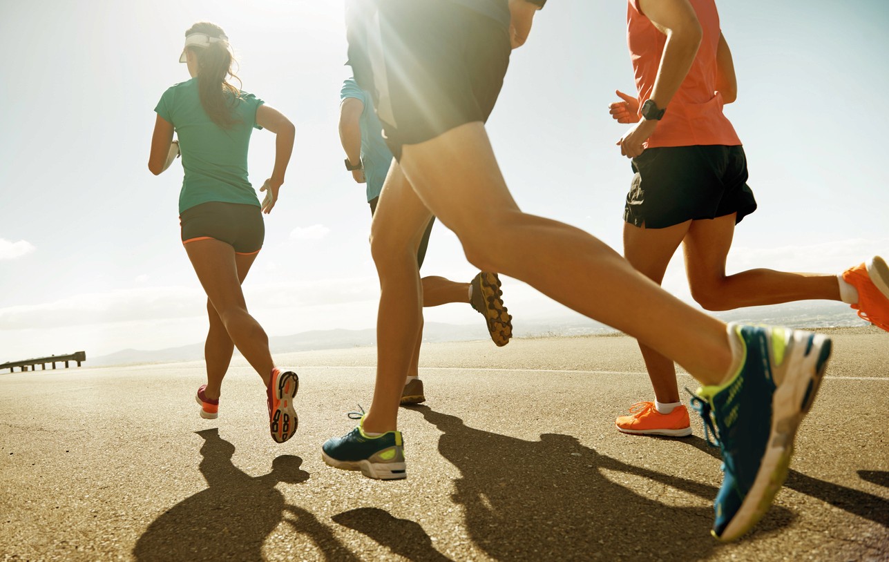 People running on the beach creating a lasting healthy habit
