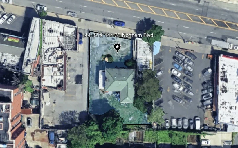 Tall modern skyscraper with vertical lines, viewed against a clear blue sky.