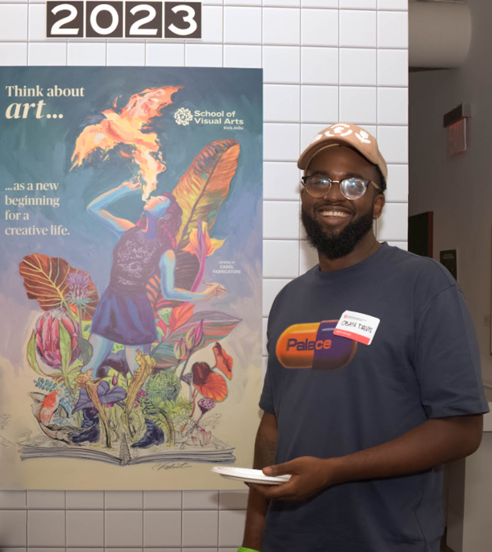 Obasi Davis, Class of 2025, man standing in front of poster