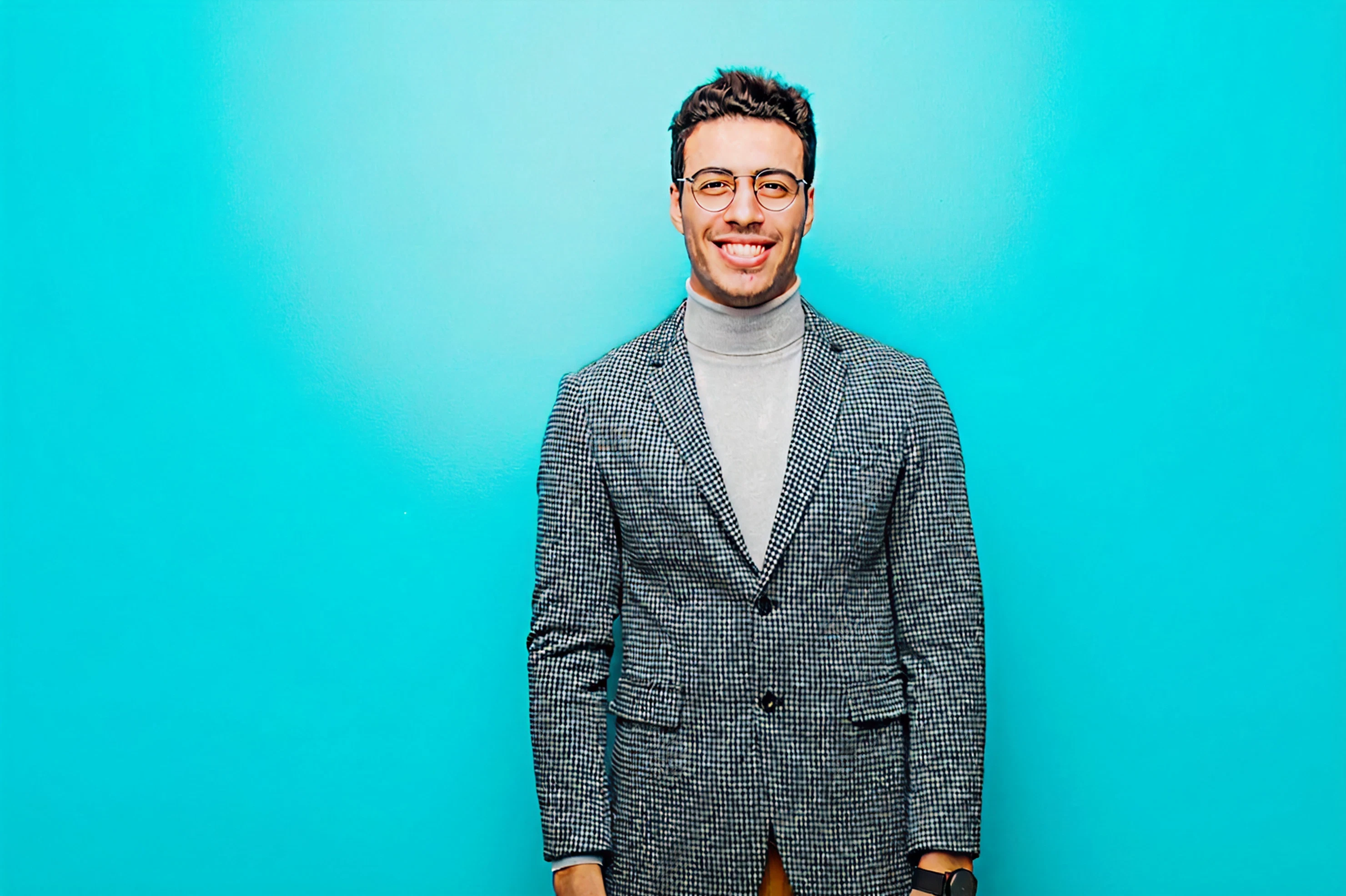 Smiling male patient wearing glasses and blazer in patient review card with five-star rating.