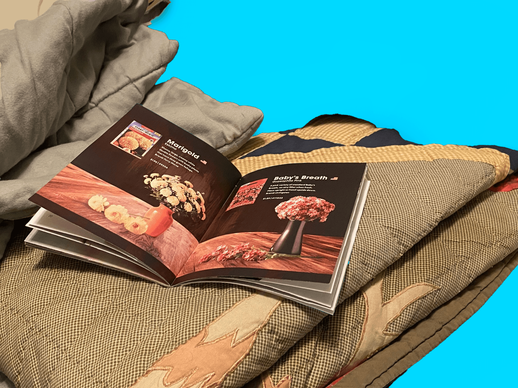 Open spread of the catalog, laying on blankets in a lifestyle photo.