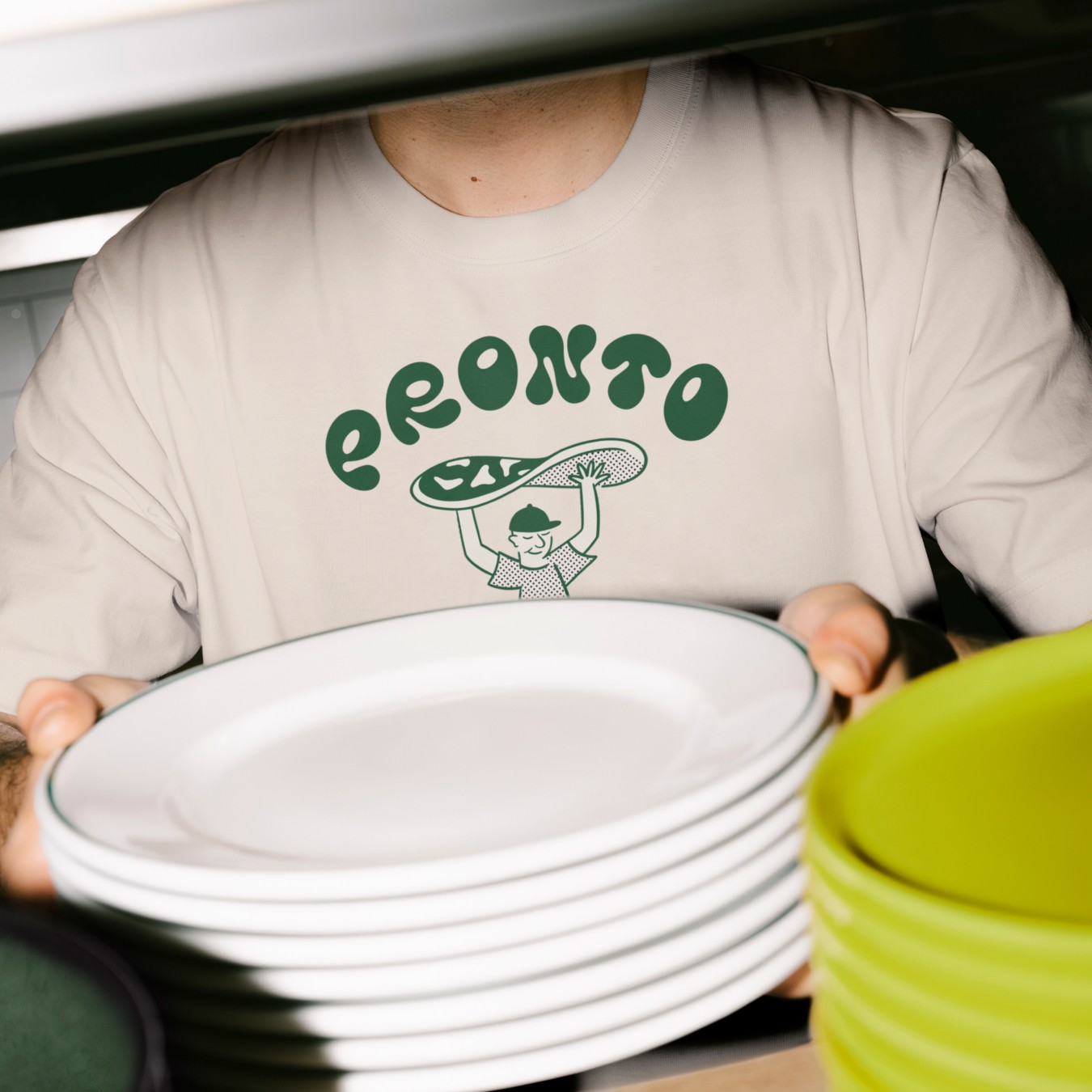 Photo of a man in a kitchen with a Pronto branded t-shirt.