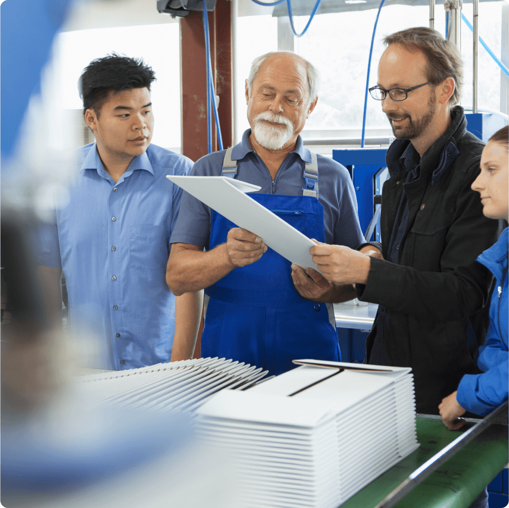 A man wearing blue shirt working on laptop inside server room