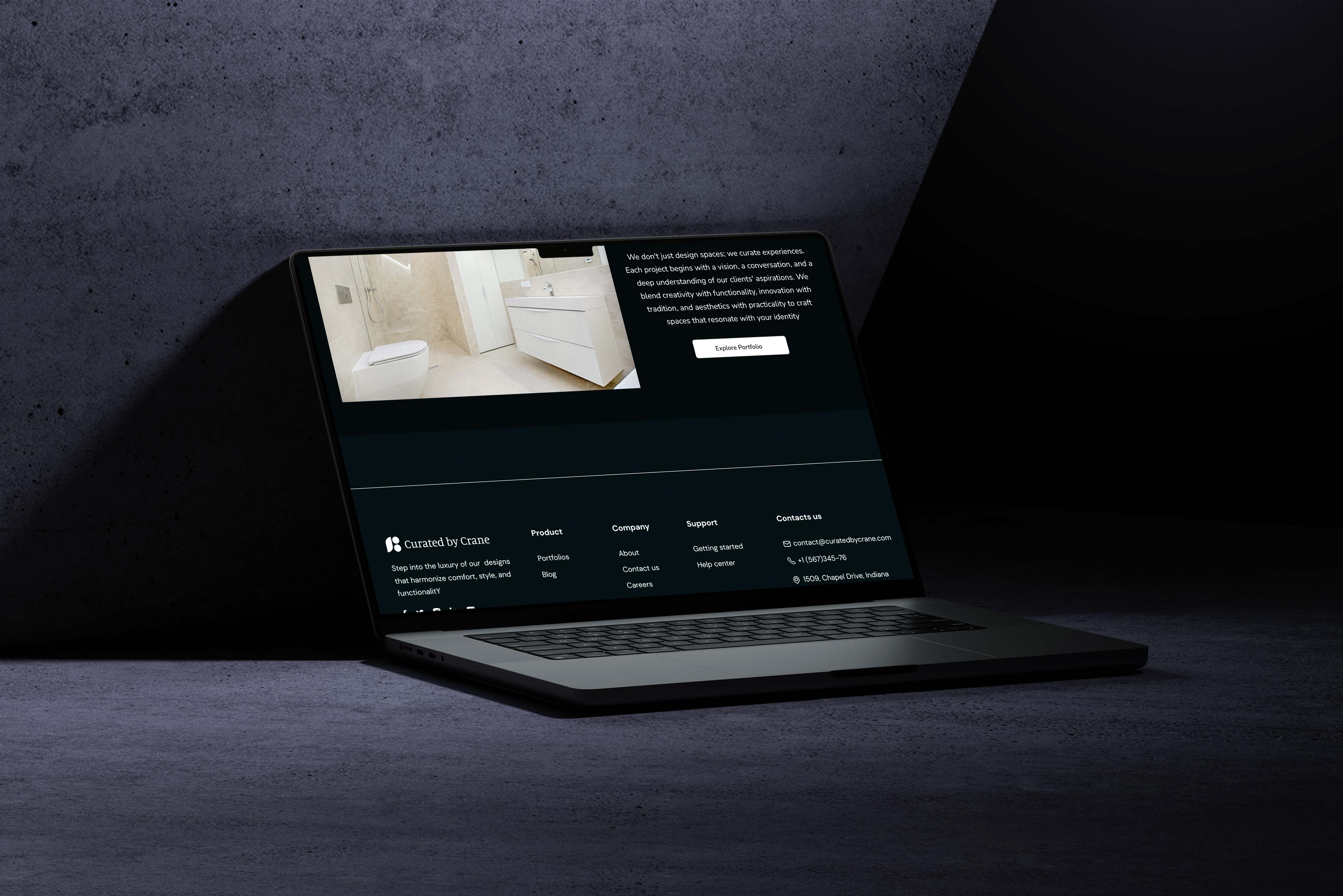 A sleek, modern laptop displaying a dark-themed website with a UI design mockup, showcasing a clean and minimalist user interface with an image of a bathroom and accompanying text, ideal for UI designers and web designers focusing on mobile and web design aesthetics.