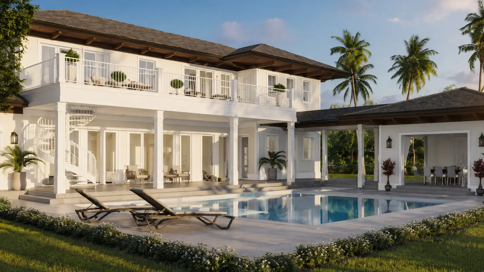 Rear view of a two-story British Colonial estate in Coconut Grove with wrap-around second-floor balconies, a covered pavilion, pool, sun loungers, and palm trees.