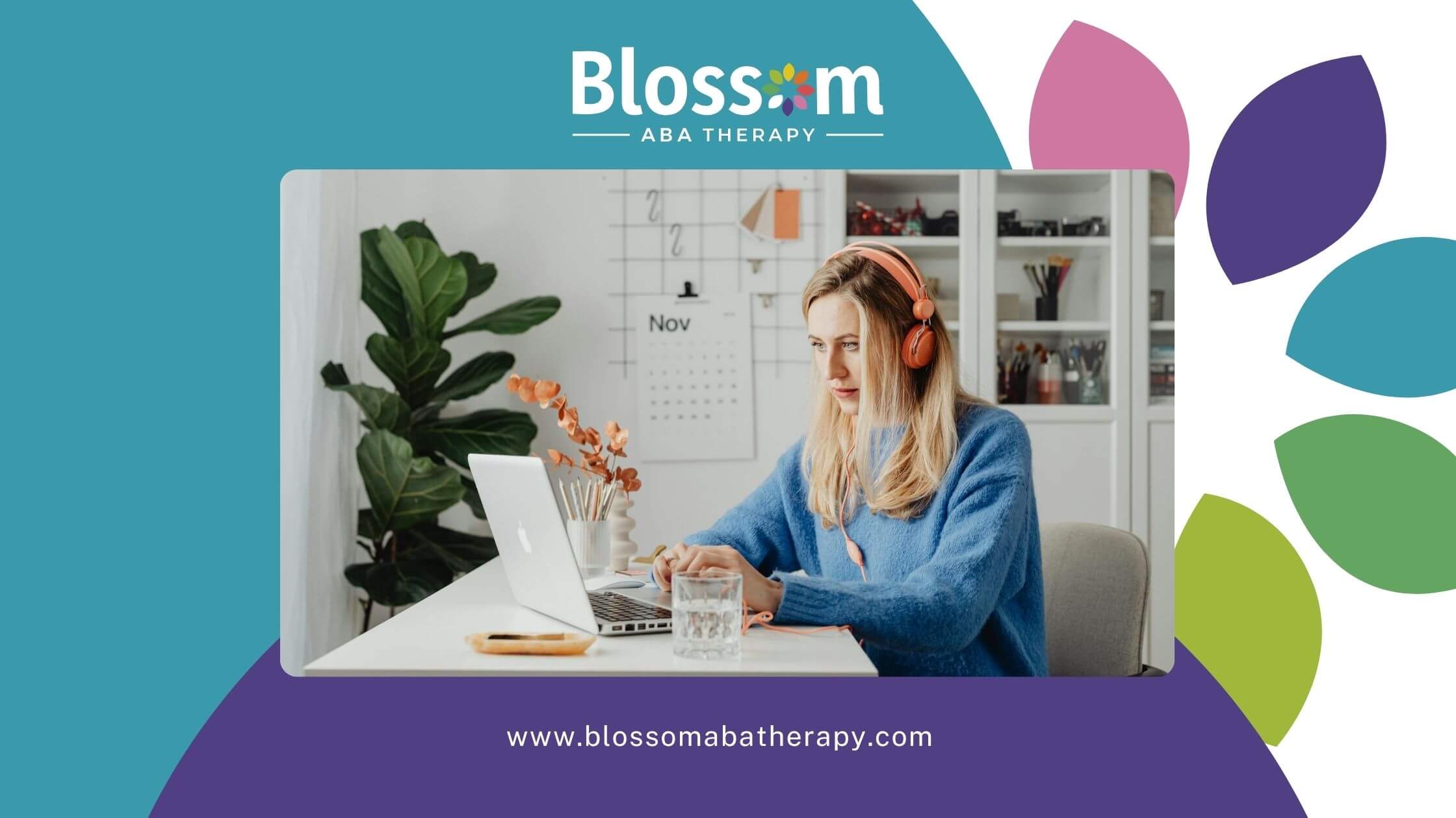 Female ABA therapist in orange headphones works on laptop at a desk with snacks, books, and calendar.